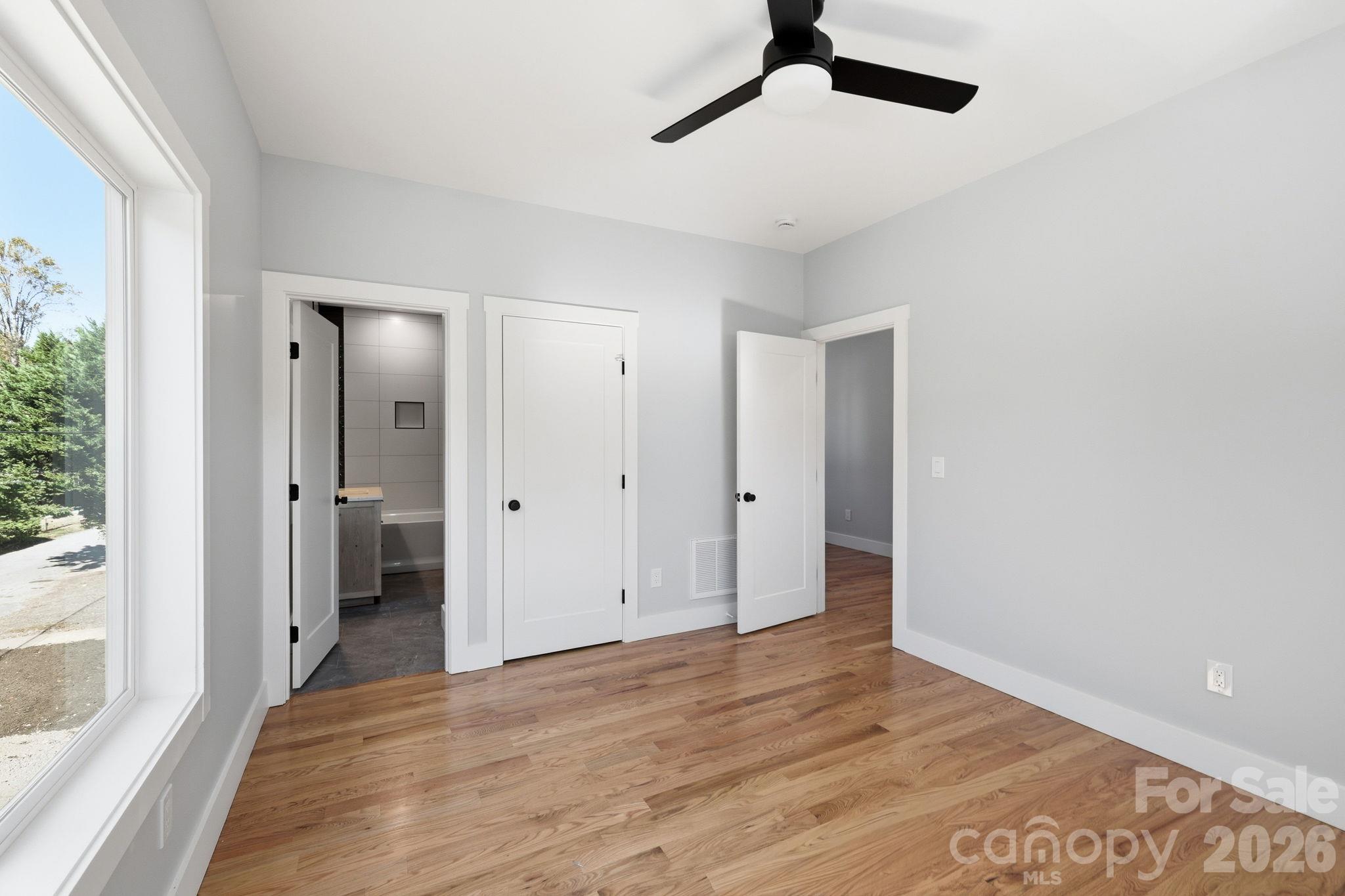 View of the second bedroom into the second full bathroom - 20 Laurel Loop, Asheville