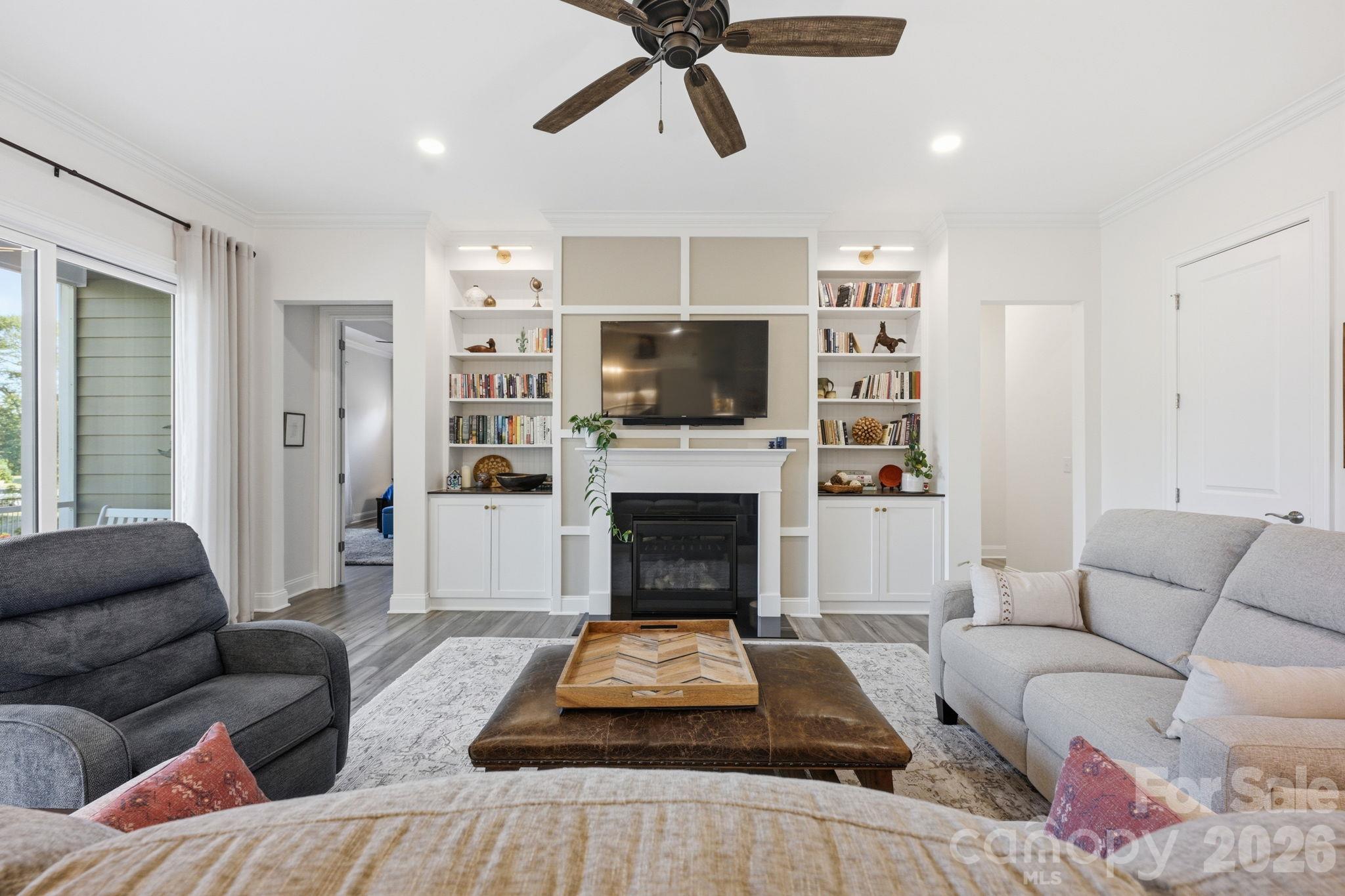 The gas fireplace is the central focus for custom built-ins - 4025 Pollock View, Mount Holly