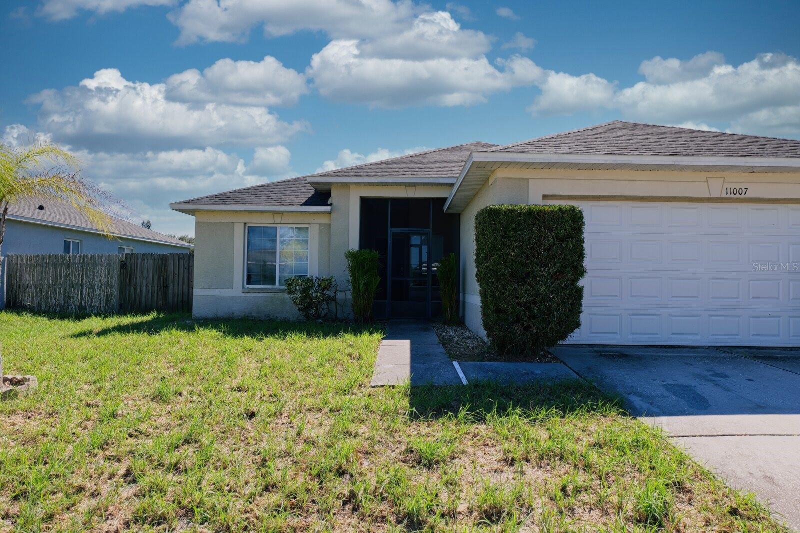Rear exterior view of the home showing the backyard and patio. - 11007 WHITECAP DR, RIVERVIEW