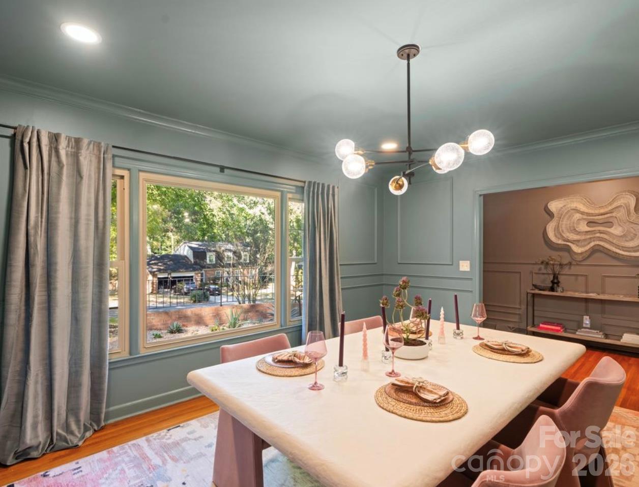 This luxurious dining suite just off the foyer welcomes guest, family and friends. Natural light engulfs this room thru the large picture window. - 6626 Rocky Falls Road, Charlotte