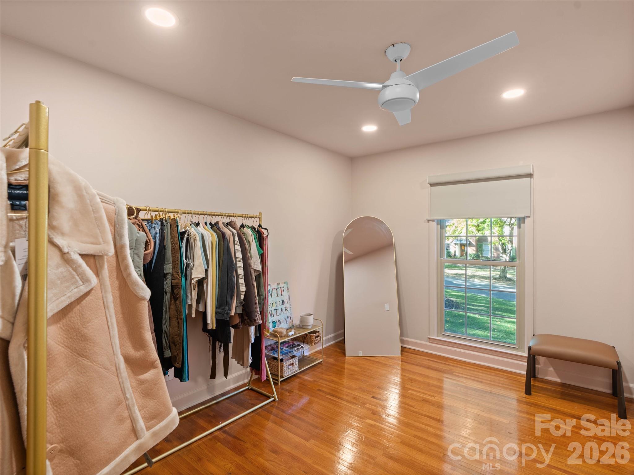 The third bedroom on the main level has been transformed into a stylish, boutique-inspired dressing room, offering a unique and elegant space - 6626 Rocky Falls Road, Charlotte