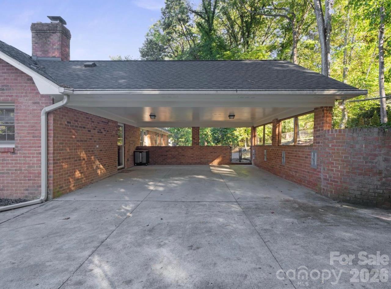 2 car covered carport located in the rear of the house attached to the main level - 6626 Rocky Falls Road, Charlotte