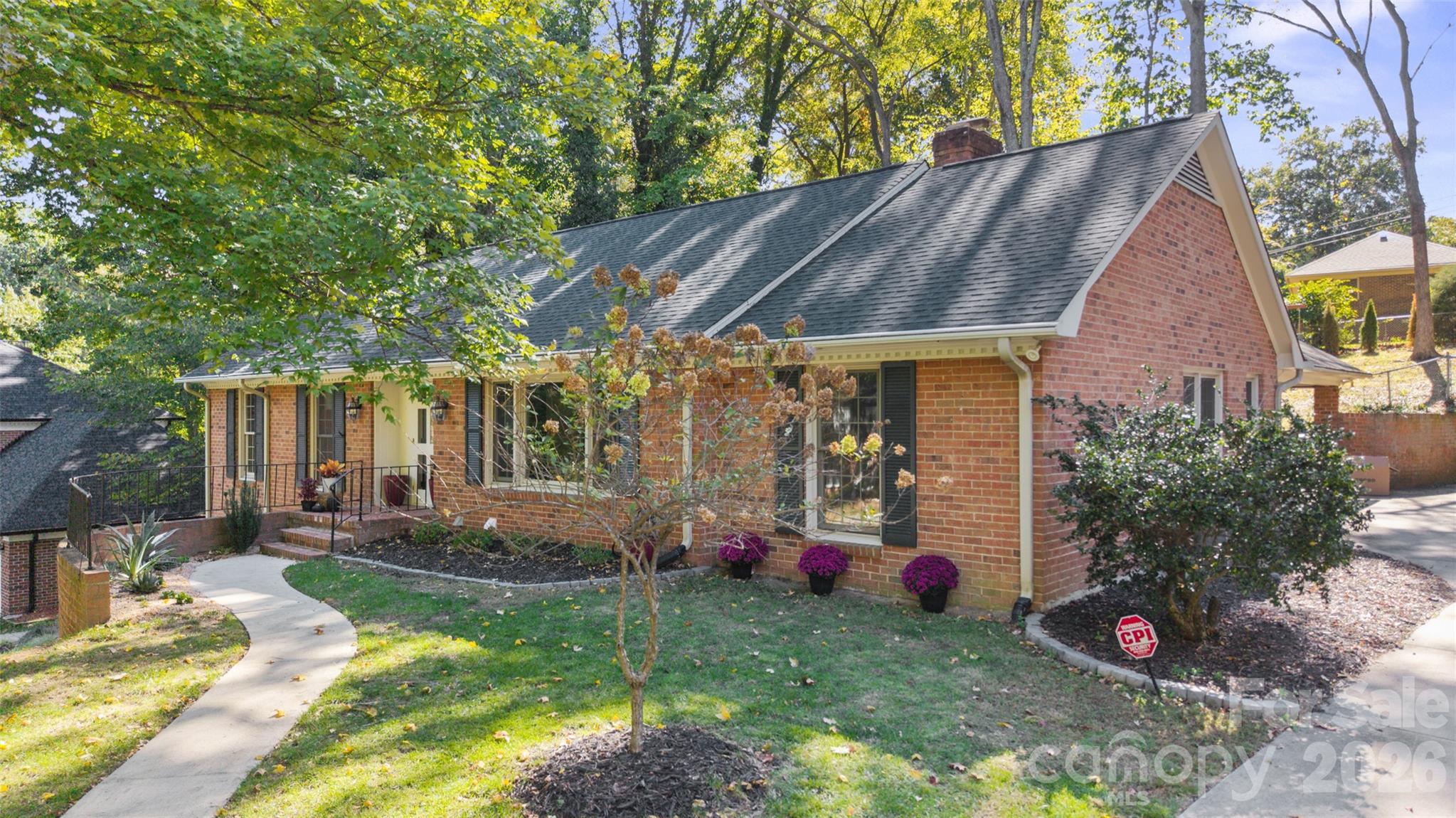 Front and side view showcasing the front sidewalk and access to the carport at the back of the property. - 6626 Rocky Falls Road, Charlotte