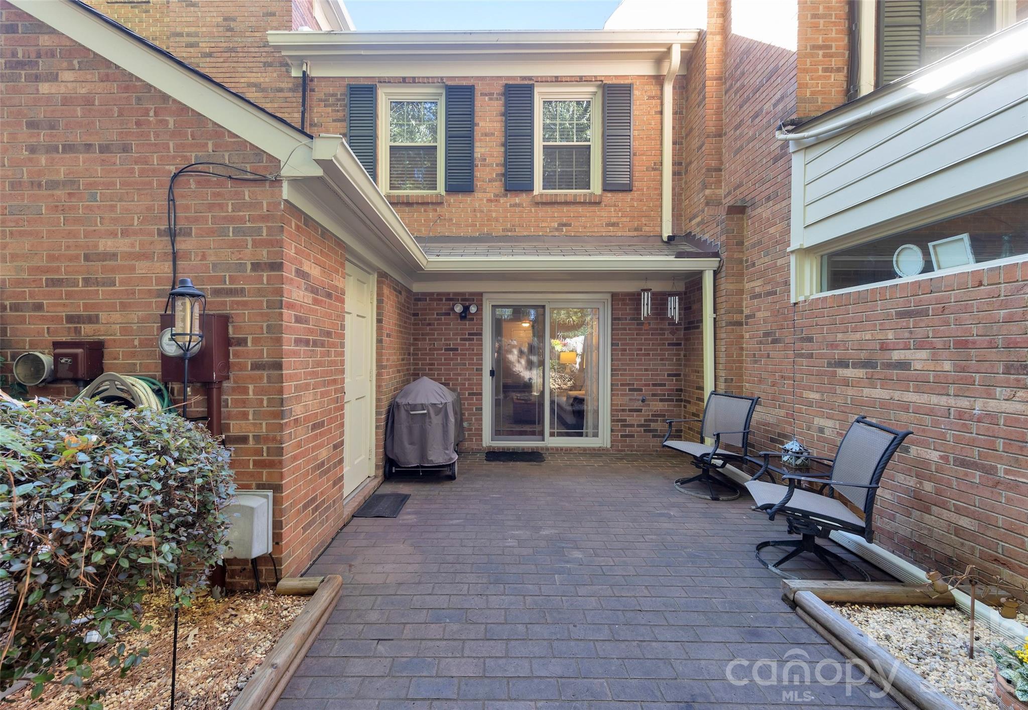 Back Brick Patio off of Great Room with Large shelved Storage - 9004-C Nolley Court, Charlotte