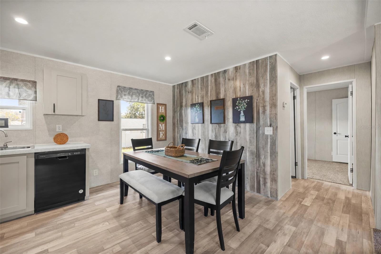 Dining Room open to kitchen with Wood look wall - 1560 NE 162ND ST, CITRA
