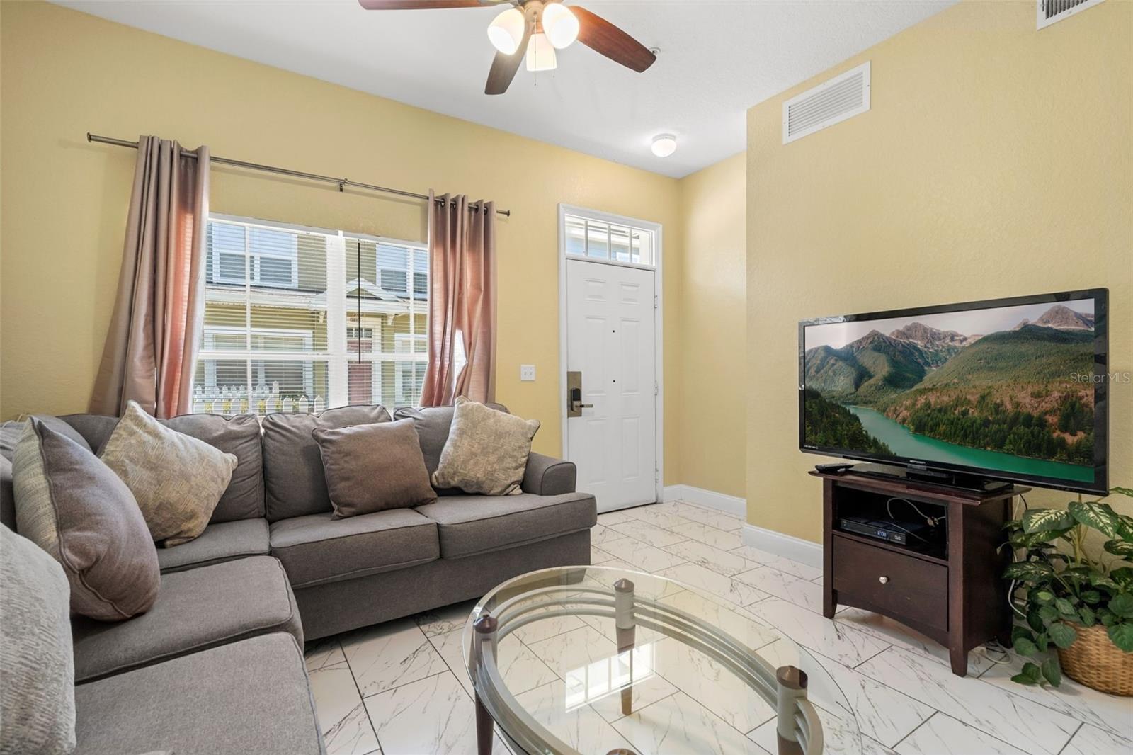 Living Room / Front Door - 4600 YELLOWGOLD RD W #105, KISSIMMEE