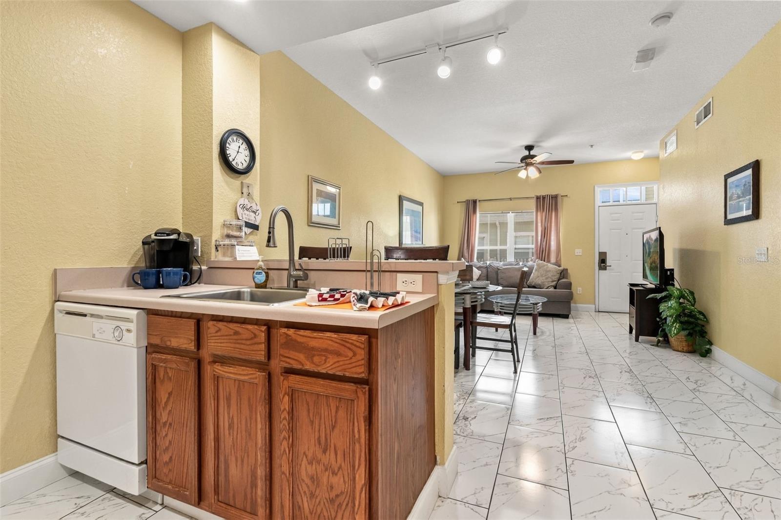 Kitchen with high-top seating. - 4600 YELLOWGOLD RD W #105, KISSIMMEE