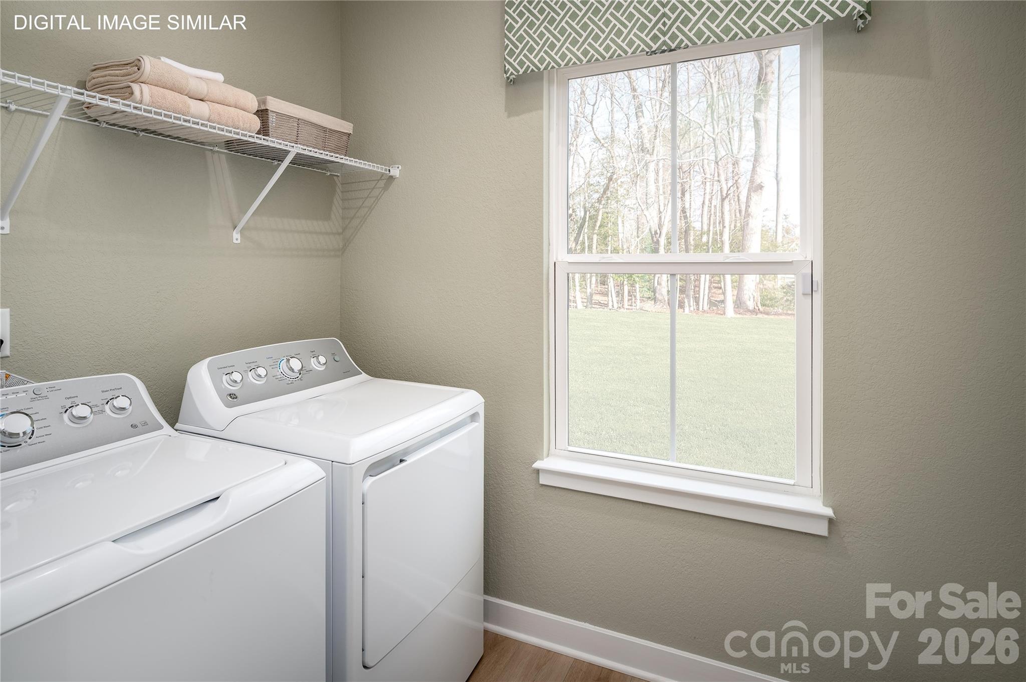 First-floor laundry room with optional utility sink—conveniently located for everyday use. - 11237 Emerson Landing Drive, Charlotte