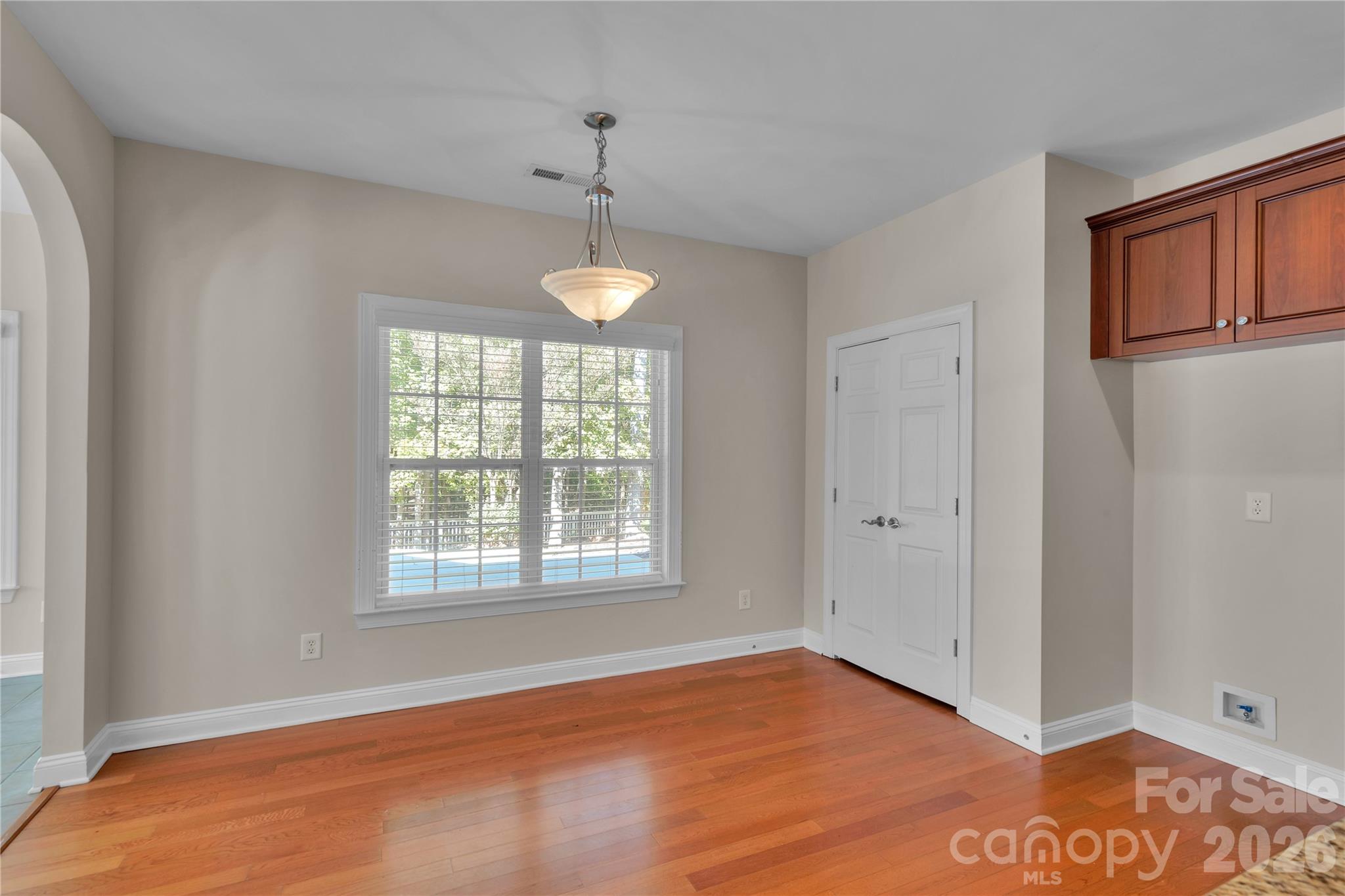 Kitchen eating area overlooking backyard and pantry - 1240 Saint Johns Avenue, Matthews