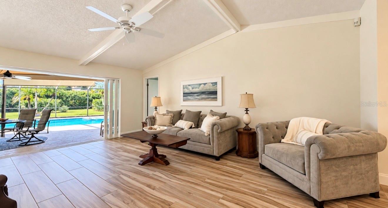 Living room with 3 pocket sliders - 9690 LEEWARD AVE, LARGO