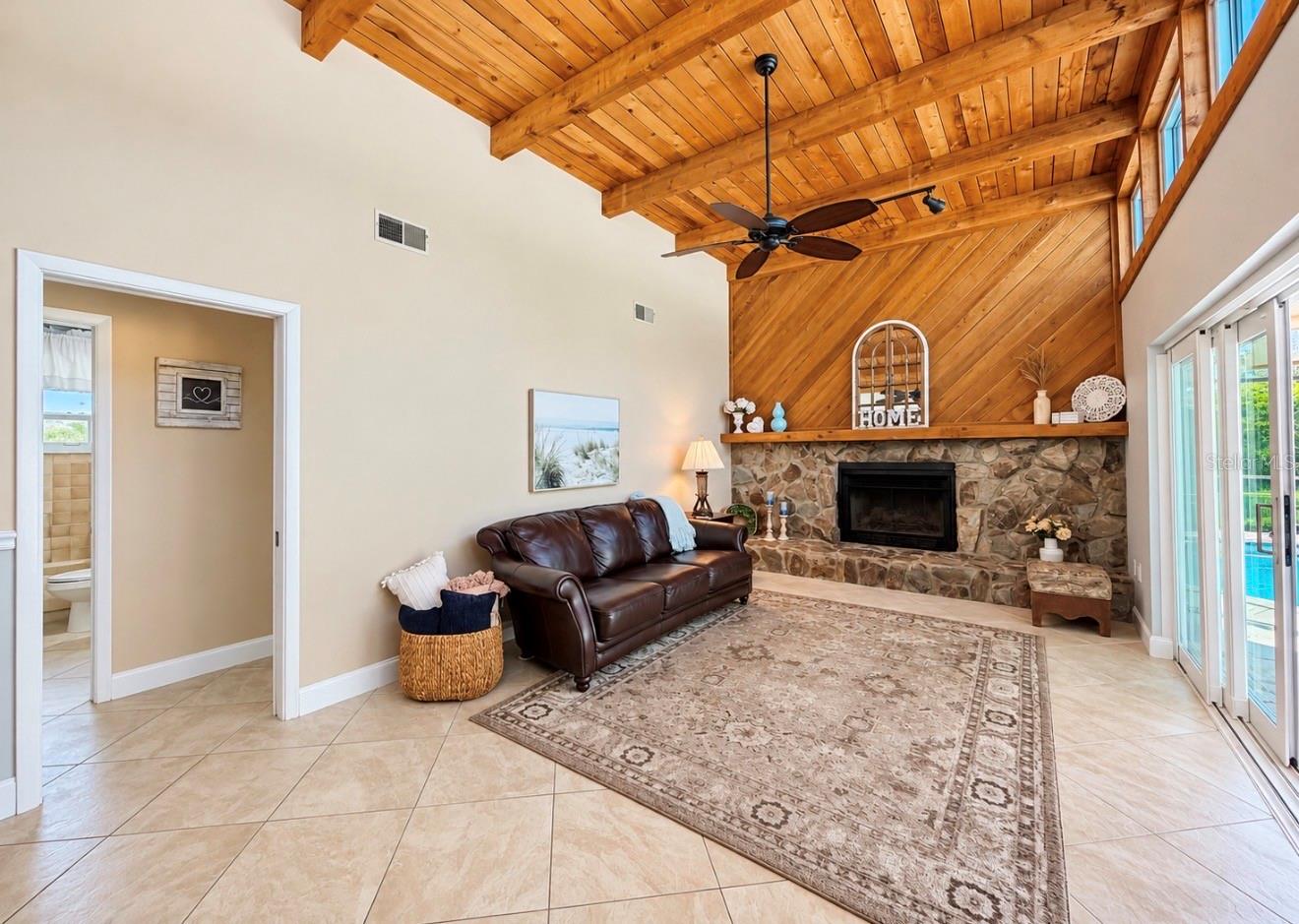 Family room with natural light and fireplace off 2nd and 3rd bedroom hallway - 9690 LEEWARD AVE, LARGO