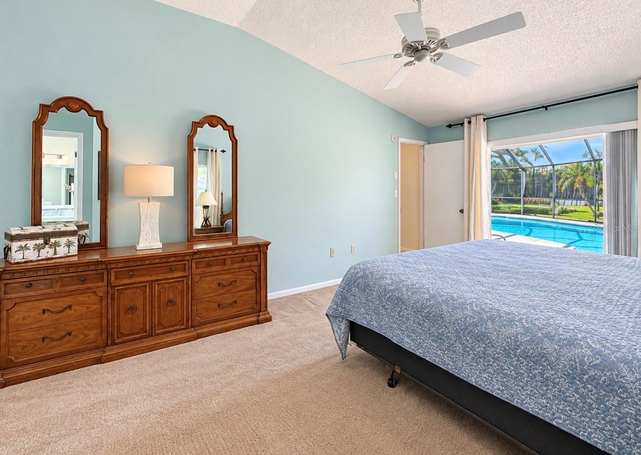 Primary bedroom leads to pool lanai - 9690 LEEWARD AVE, LARGO