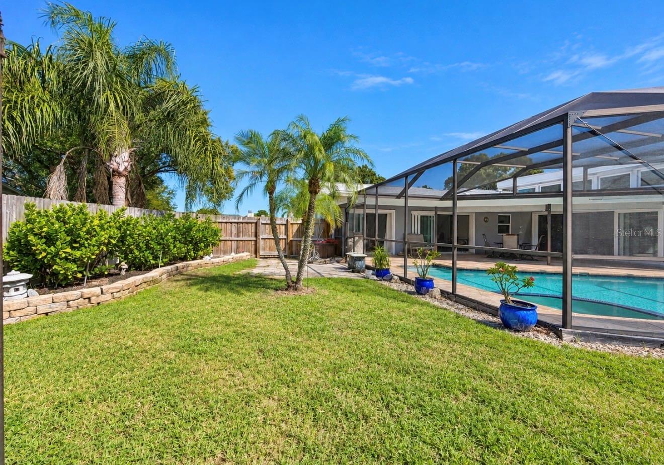 Yard with pool enclosure - 9690 LEEWARD AVE, LARGO