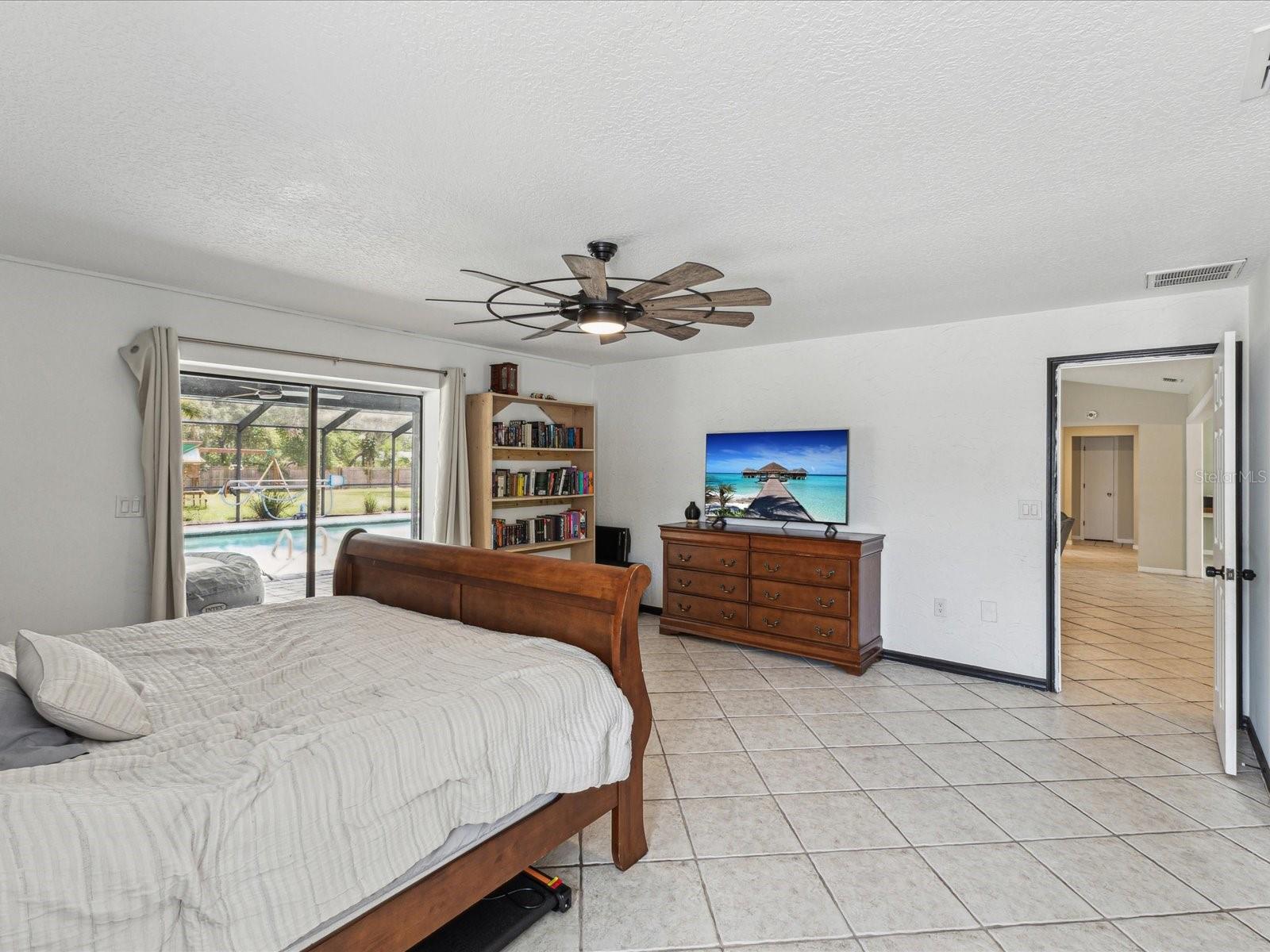 Primary Bedroom with Sliders to Patio and Pool - 1222 HUNTINGTON AVE, SPRING HILL