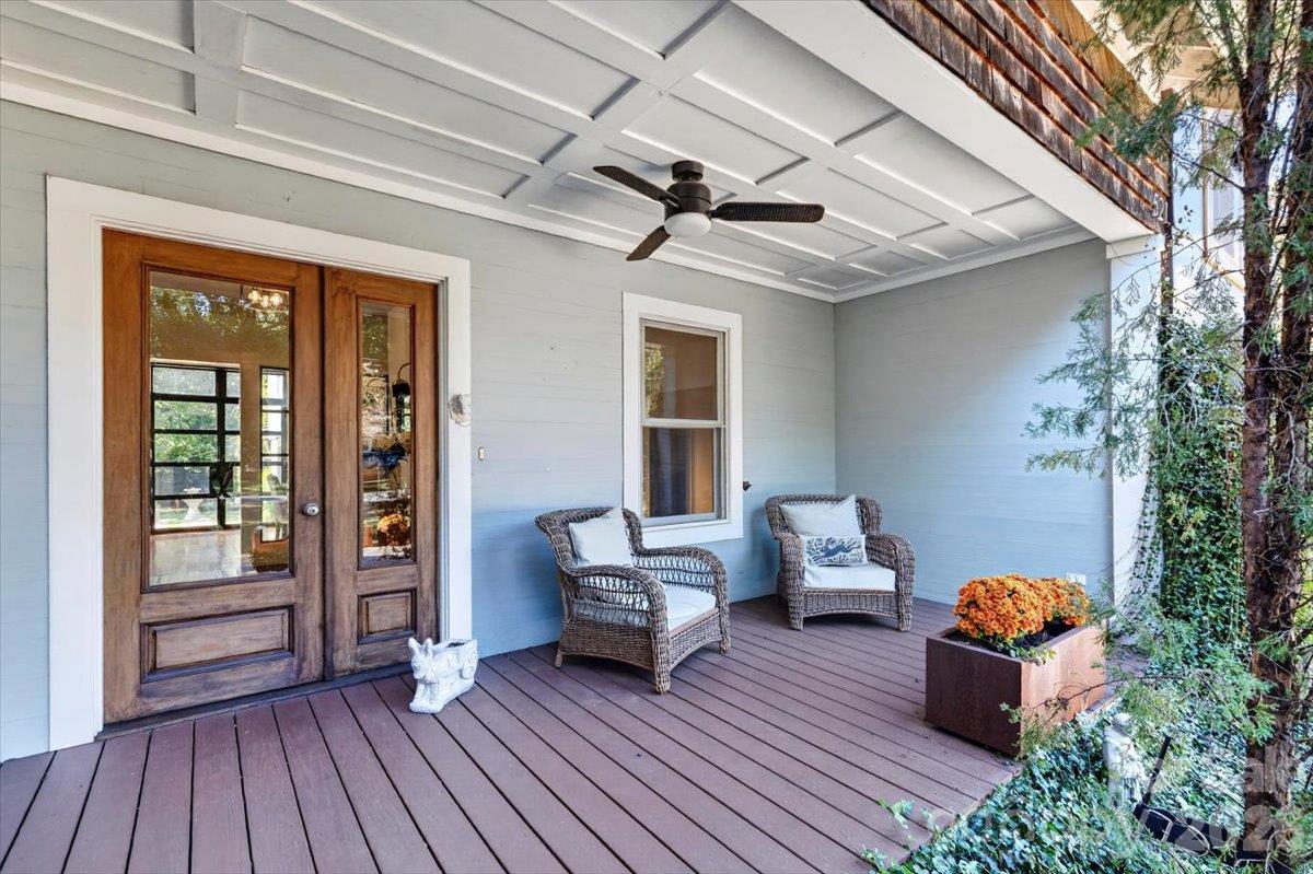 Enjoy your sweet tea or favorite beverage on this covered front porch under a fan designed to keep the breezes moving. The shingle above adds architectural depth. - 521 Forest Lane, Rock Hill