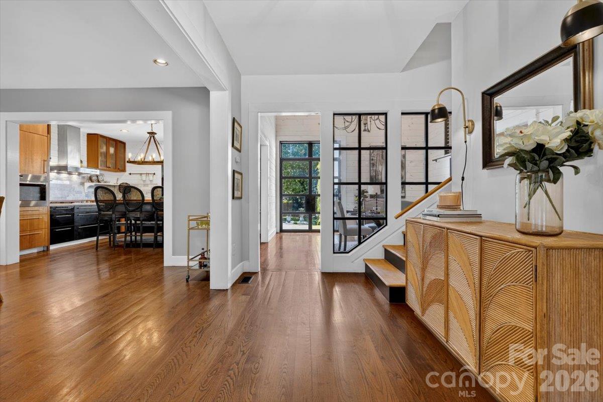 Step in to find a welcoming lobby and a peek at the dining area, kitchen, and breakfast room. Turn right towards the drop zone, storage, a powder room, and interior access to the garage. - 521 Forest Lane, Rock Hill
