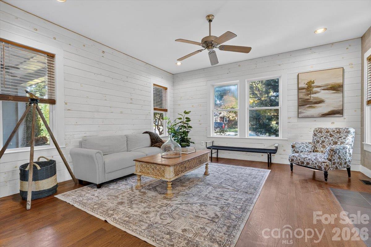 The living room has windows on three sides, bringing light into the space. - 521 Forest Lane, Rock Hill
