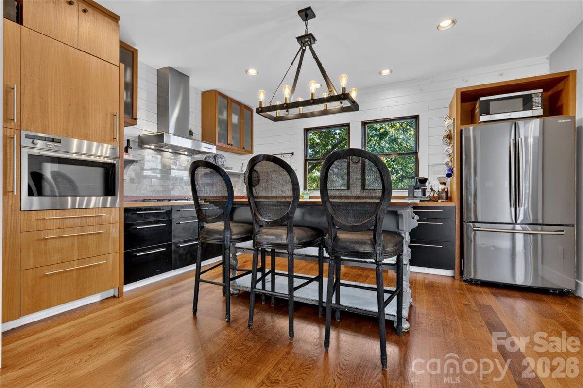 Start the day at the island with a coffee while sunlight filters through the trees outside the double windows. The glow of the pendant makes evenings feel just as good. Pour a coffee, pull up a stool, and watch the trees move outside the windows. The island puts the cook and the company in the same conversation. - 521 Forest Lane, Rock Hill
