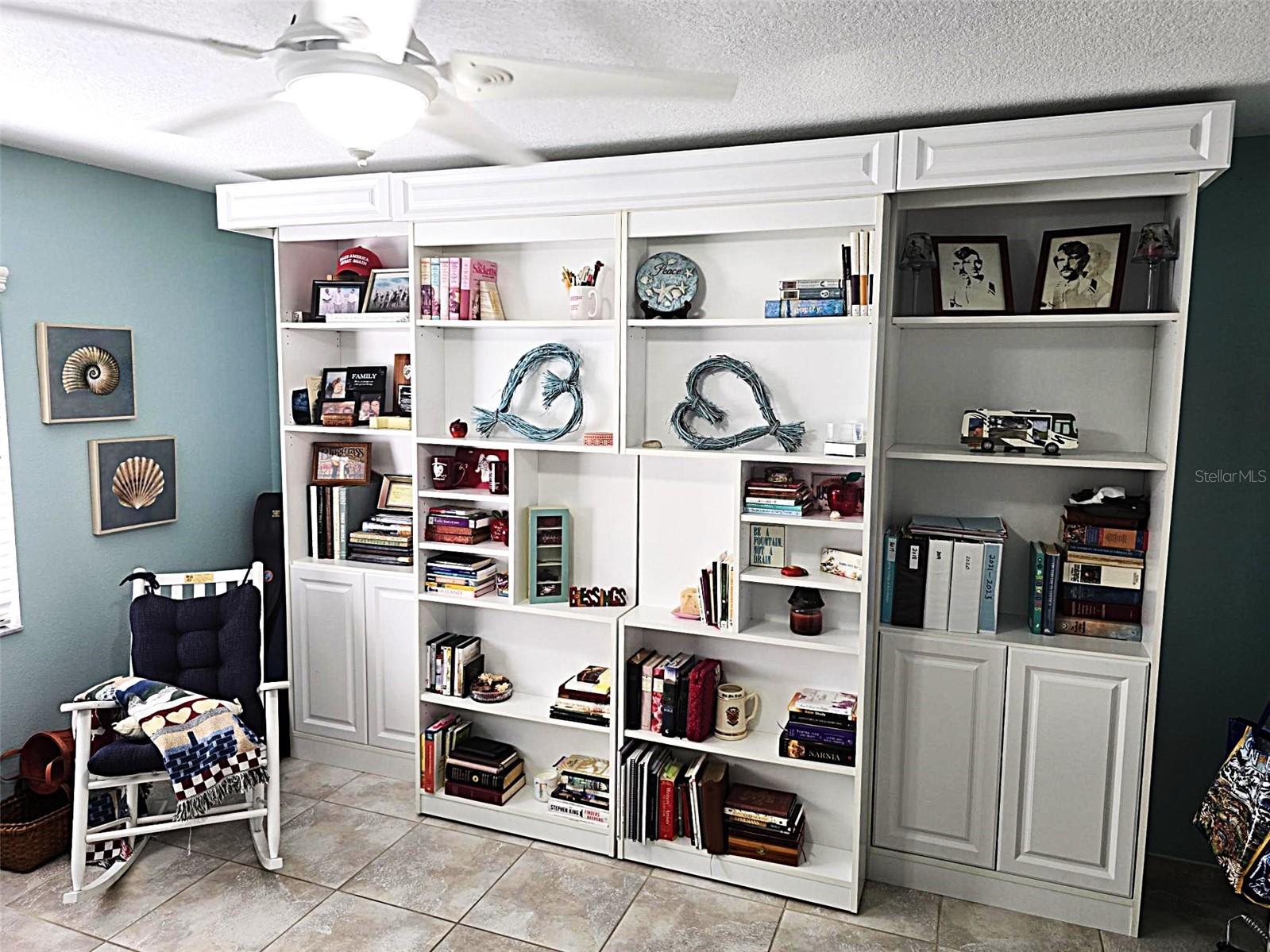 Library Style Murphy Bed shelving on rollers. - 2805 NORWOOD LN, VENICE
