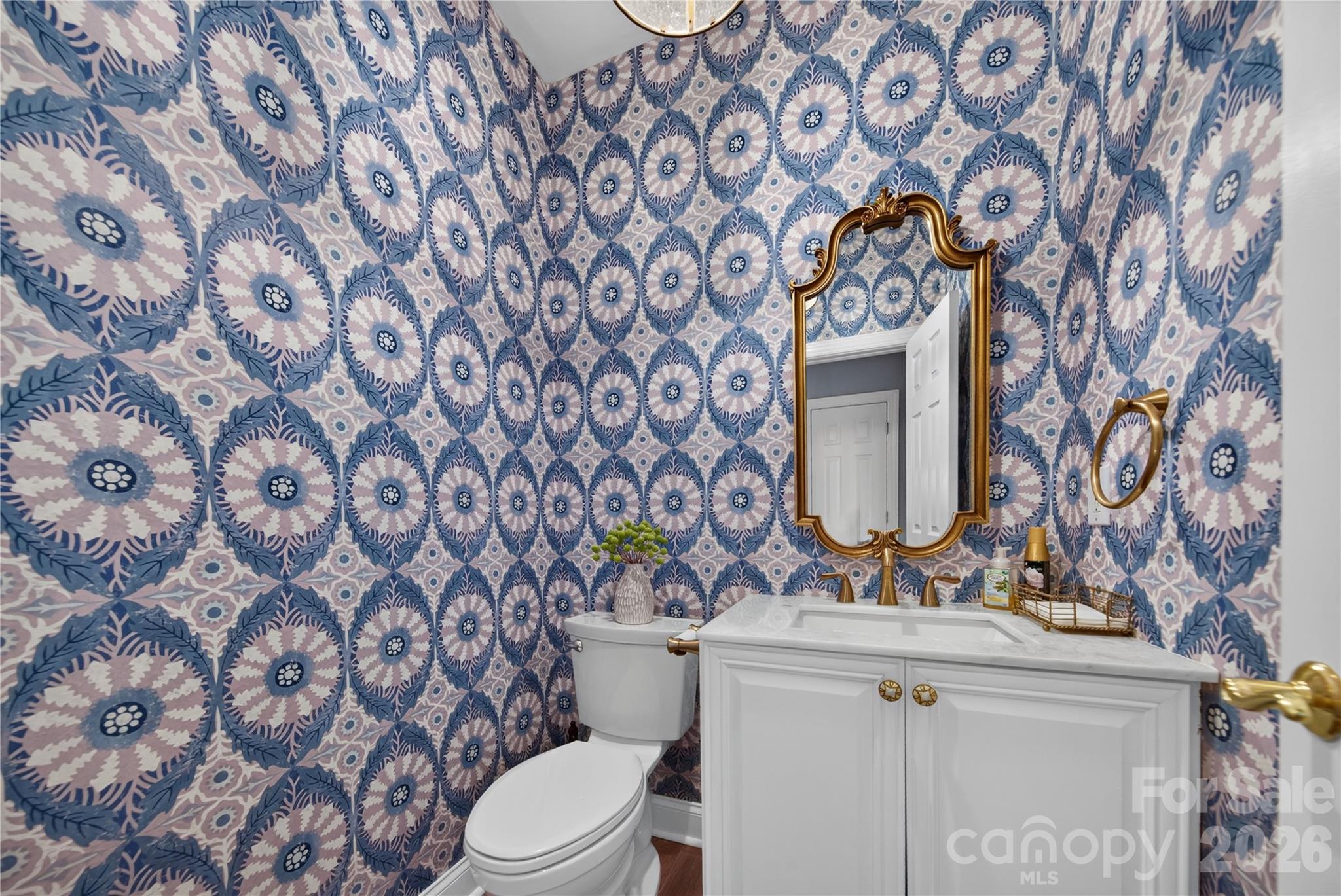 Marble vanity top, vintage chandelier and designer wallpaper make this Powder Room pop! - 9251 Bonnie Briar Circle, Charlotte