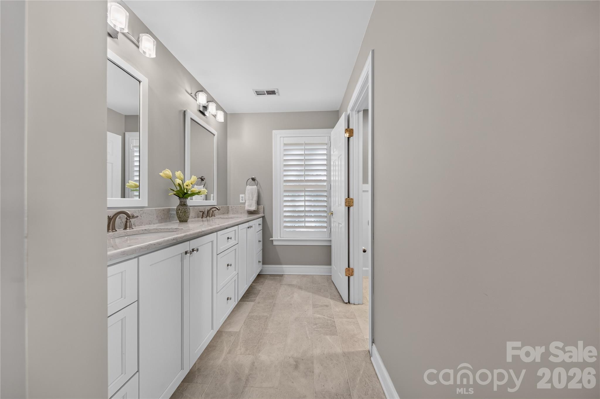 Spa Primary bath renovated with carrara marble tile throughout and quartz counter tops - 9251 Bonnie Briar Circle, Charlotte