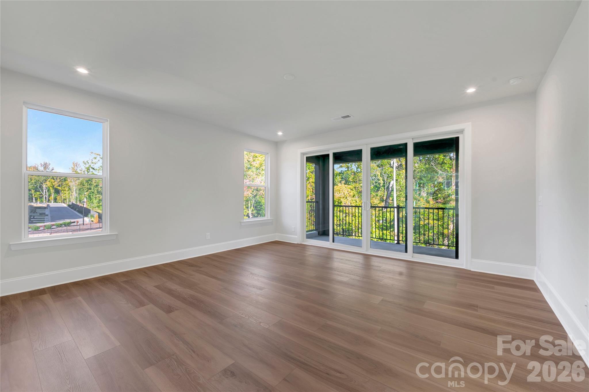 Light filled great room with large double sliding glass doors to the balcony - 240 Old Town Village Road, Waxhaw