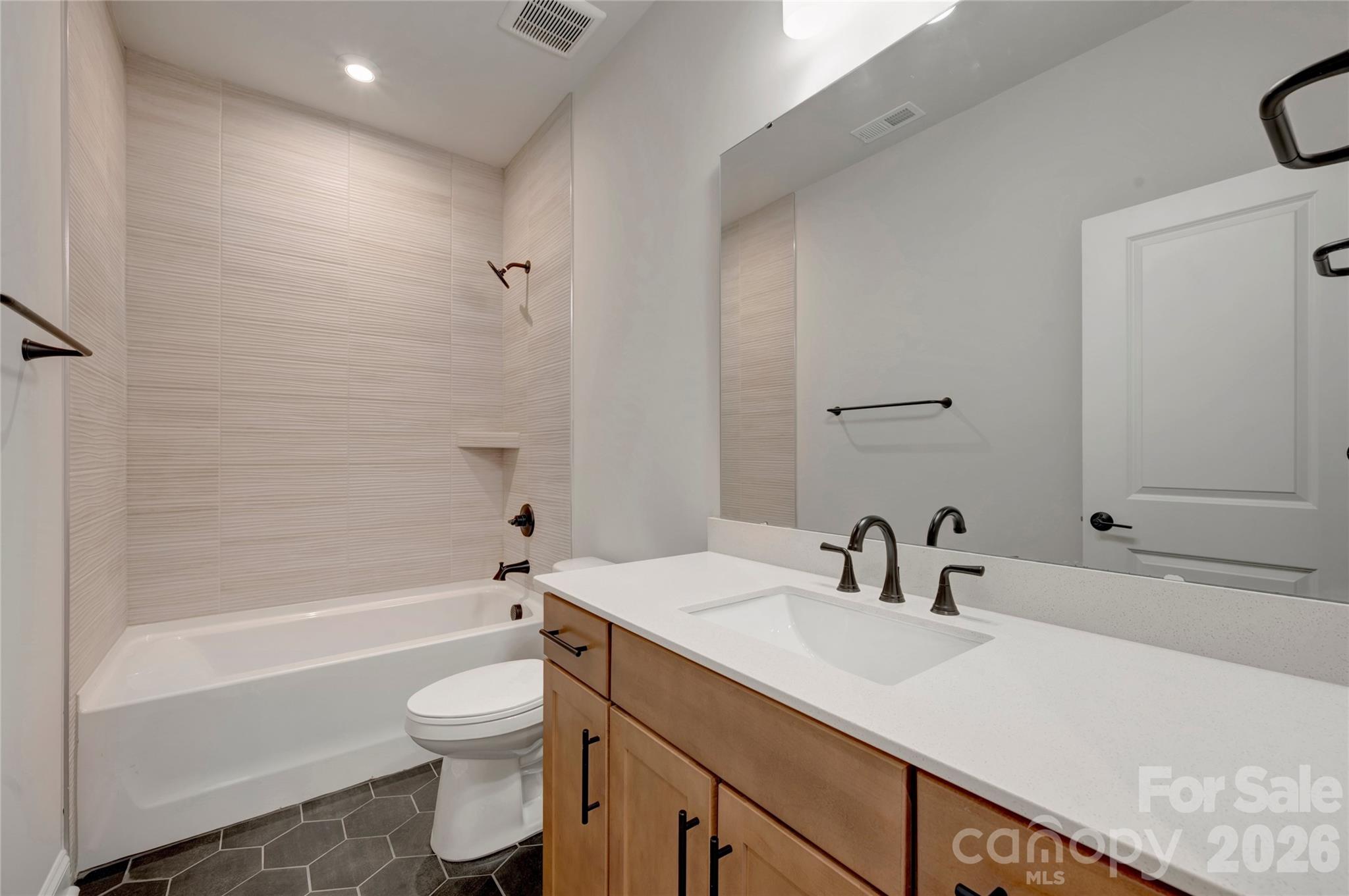 Secondary bathroom with tiled walls above the tub - 240 Old Town Village Road, Waxhaw
