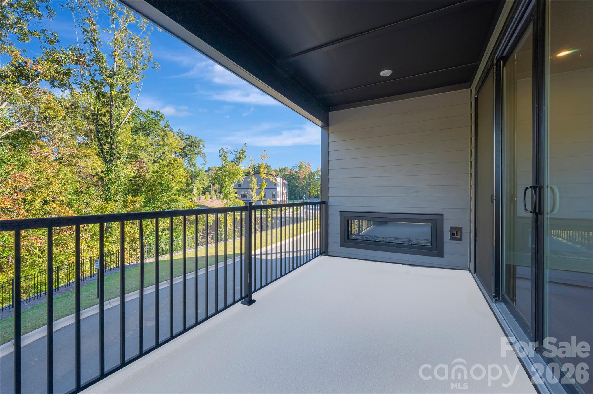 Covered balcony with an electric outdoor fireplace - 240 Old Town Village Road, Waxhaw