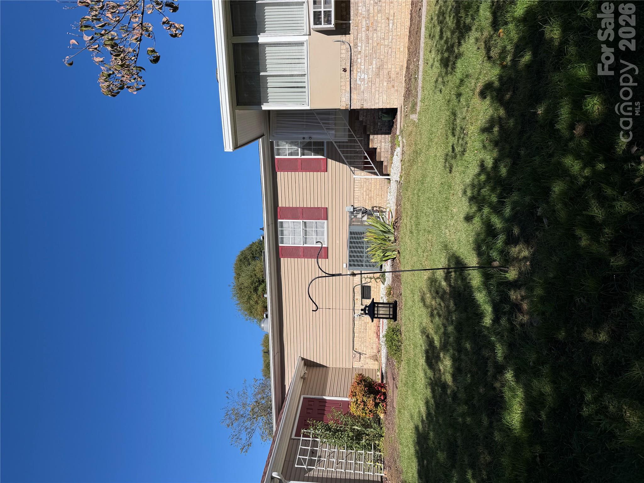 back of house; storage and sun room - 205 Misty Lane, Hendersonville