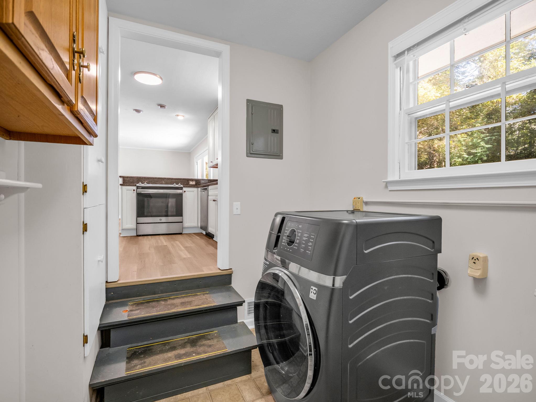 Laundry room off of kitchen with storage and 2023 All-In-One Washer/Dryer Combo - 2630 Seminole Drive, Hendersonville