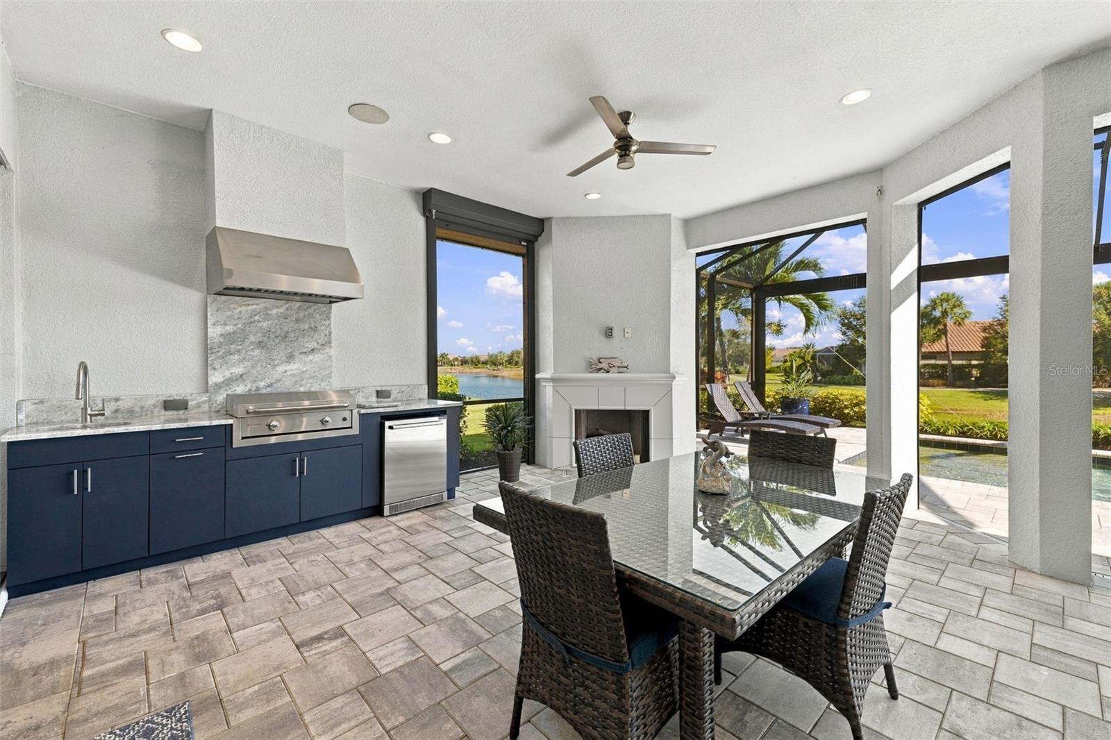 Outdoor Kitchen and Dining with a Fireplace - 4723 BENITO CT, BRADENTON