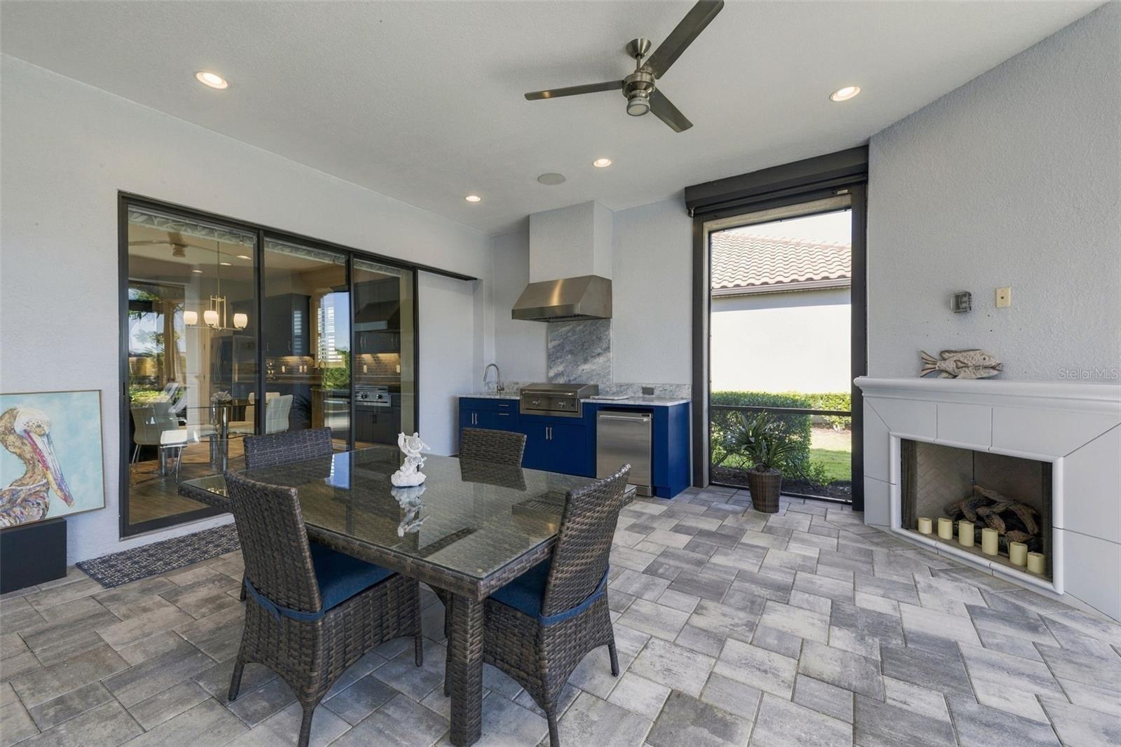 Outdoor Kitchen and Dining with a Fireplace - 4723 BENITO CT, BRADENTON