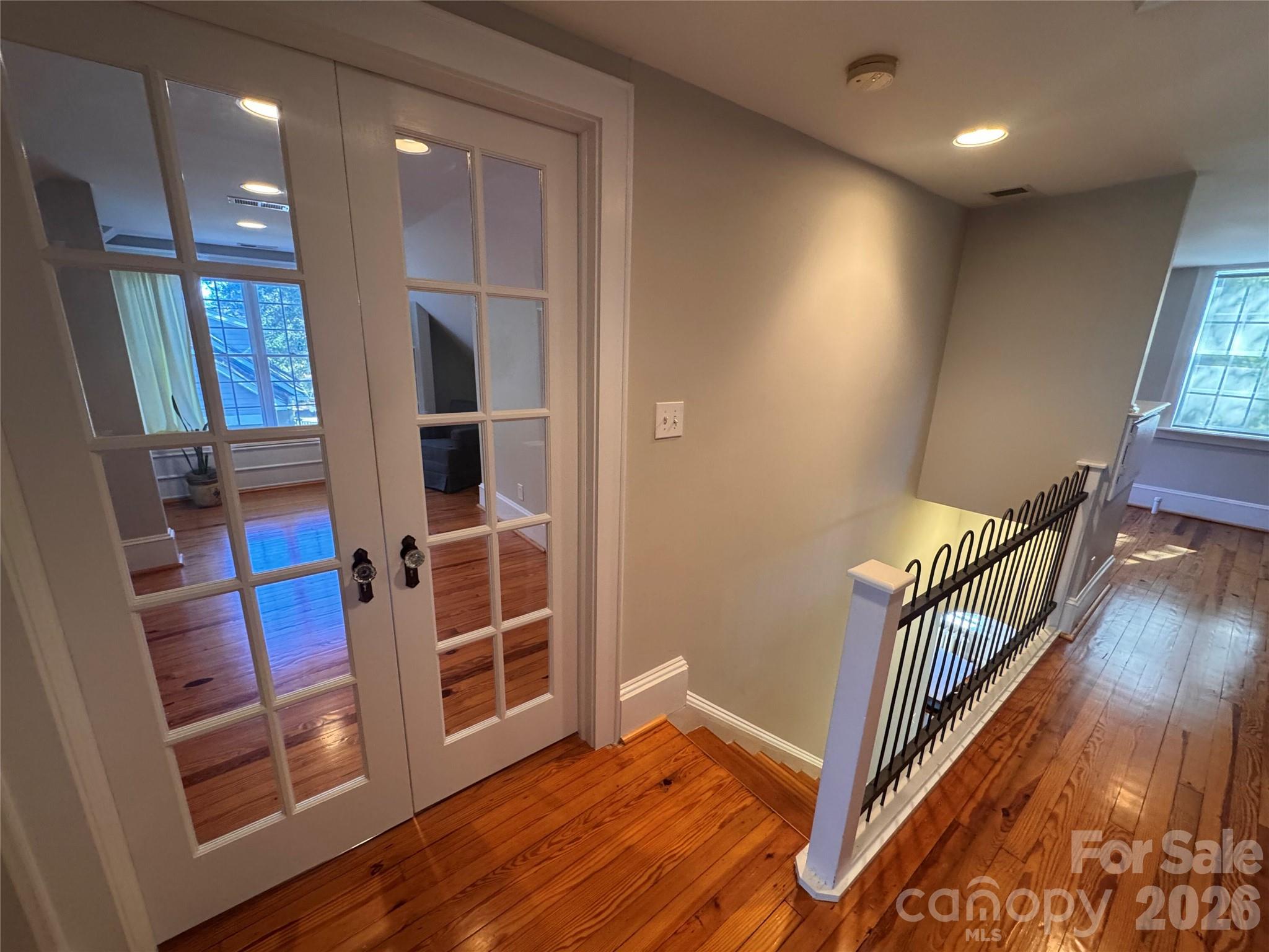 Upstairs railing and view to flex space with French doors. - 139 Louise Drive SE, Concord