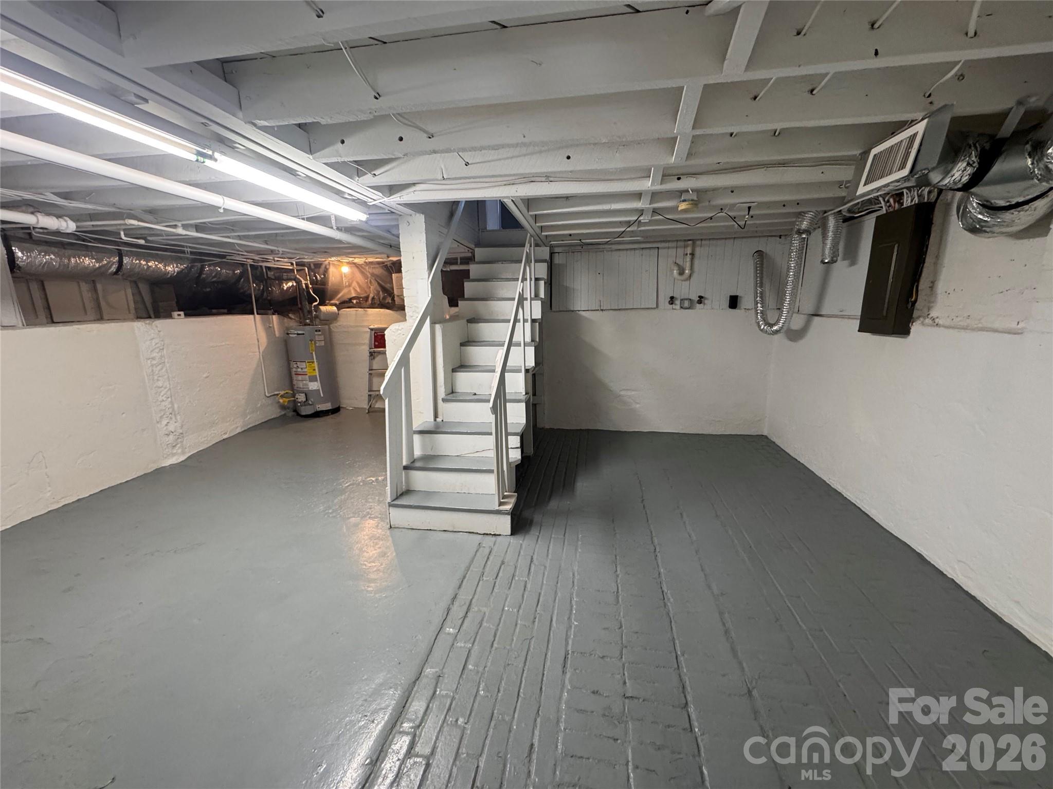 Basement does have one vent in the ductwork as seen here. Crawlspace access is at the back wall. - 139 Louise Drive SE, Concord