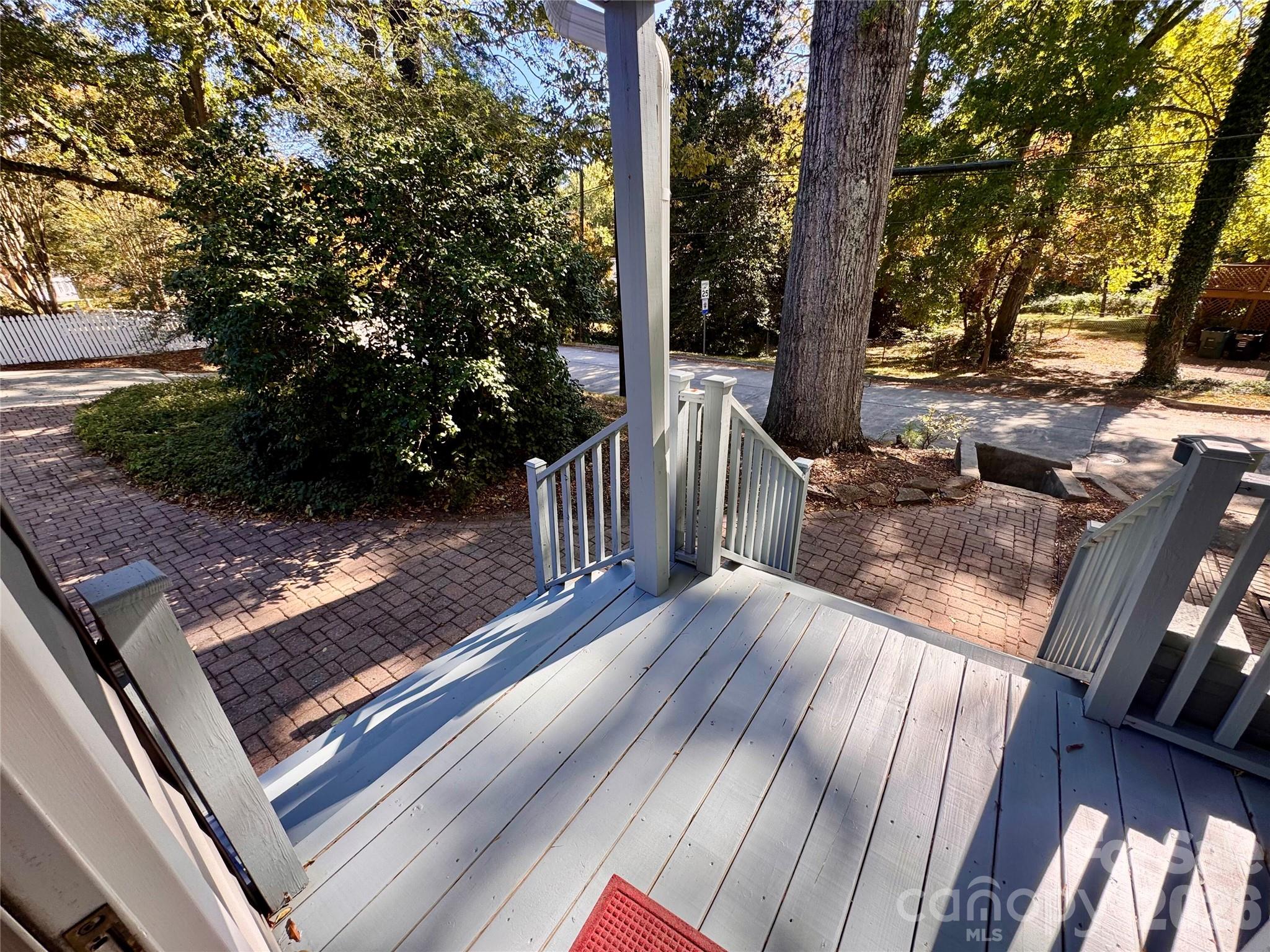 Side door covered porch leads to a street accessible sidewalks and a second sidewalk to the driveway and detached garage. - 139 Louise Drive SE, Concord