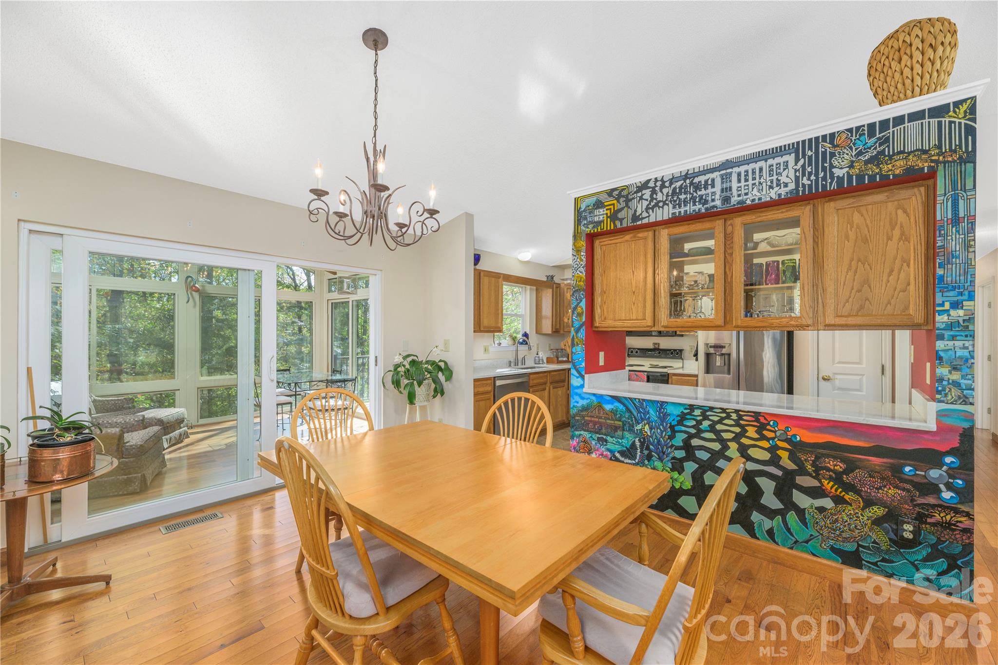 Dining area with a passthrough window and impressive mural for a conversation piece. - 6 Eagles Nest Lane, Asheville