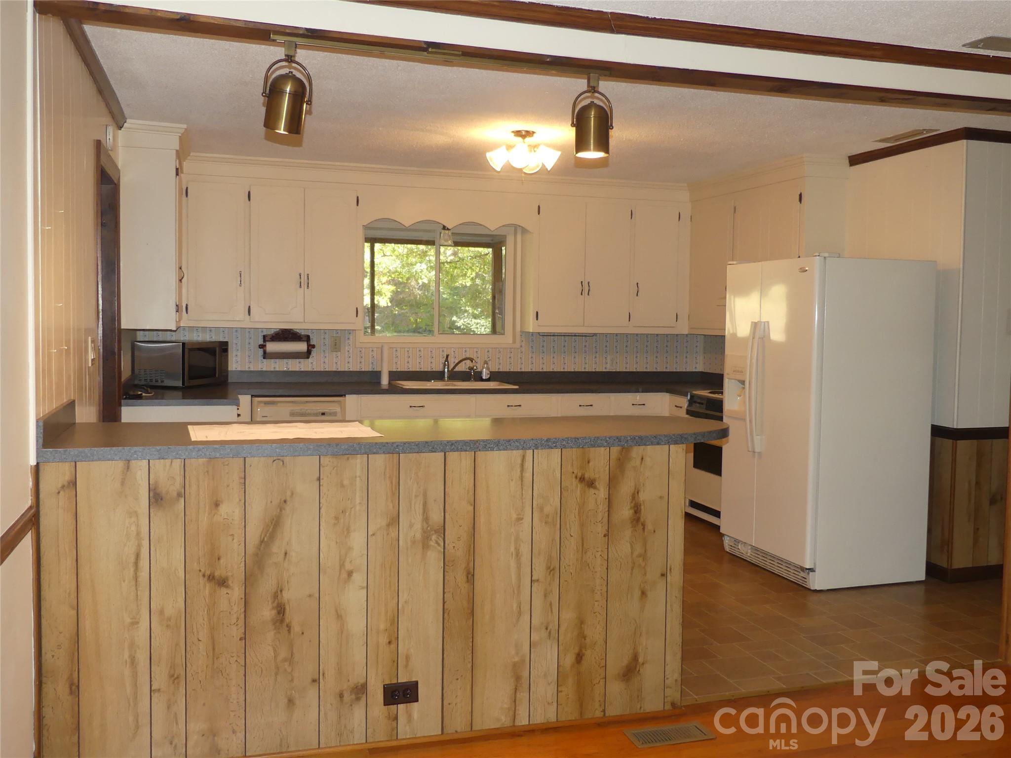 View from living room to kitchen. - 7871 Howard Avenue, Kannapolis