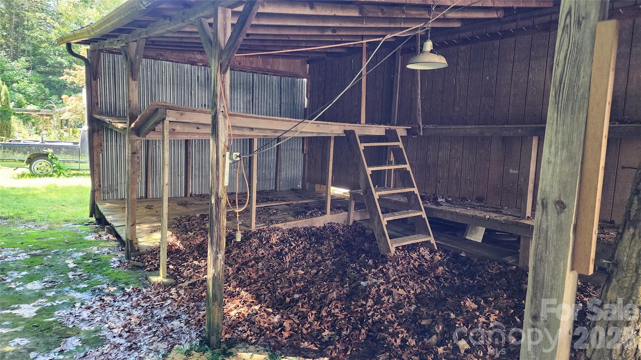 Covered shelter adjoins workshop to store recreation gear, garden tools, lawn mower - 6174 Hwy 221 Highway N, Marion