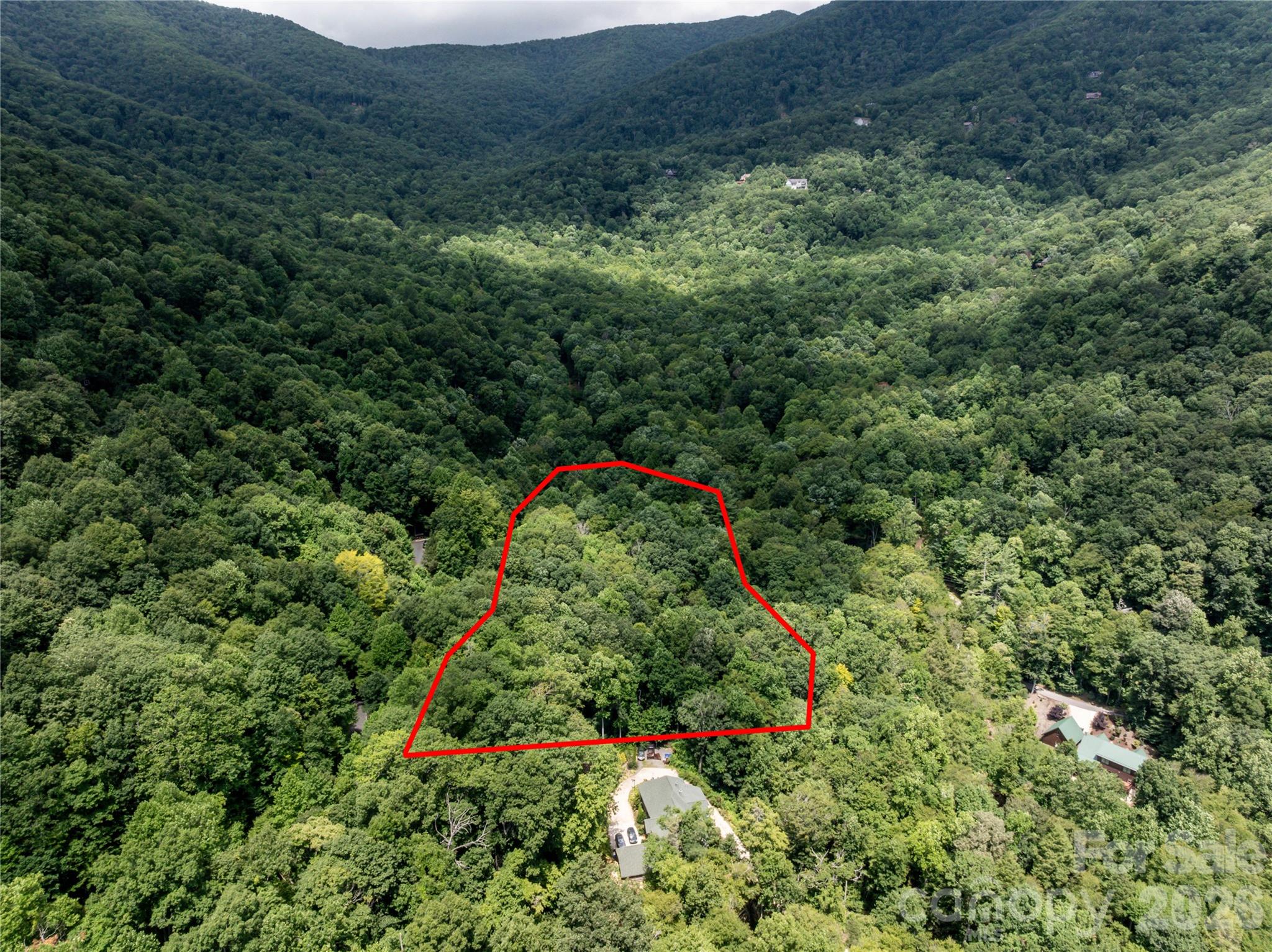 The top of this lot seen from the air, is about where the driveway would enter the lot, near the mailboxes, and where you would actually be on Hemlock Circle - If your driveway enters off Hemlock Circle, then your address would be different from 6 Great Aspen Way. Buncombe County 911 would give youi a new number and include "Hemlock Circle" as your address. - 6 Great Aspen Way, Black Mountain