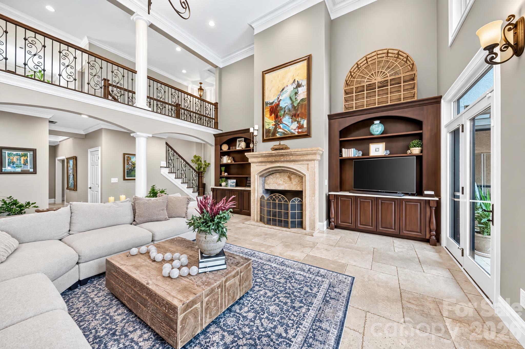Two story Great Room with fireplace and access to kitchen.  Stairs lead up to the 4th bedroom suite, office, bonus room, and loft. - 1340 Sardis Road N, Charlotte