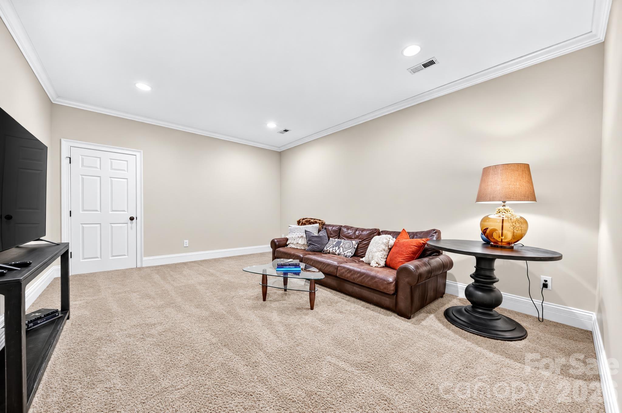 Upstairs bonus room with access to the walk in attic space providing tons of storage.  This is a perfect space for a media room, gaming, etc... - 1340 Sardis Road N, Charlotte