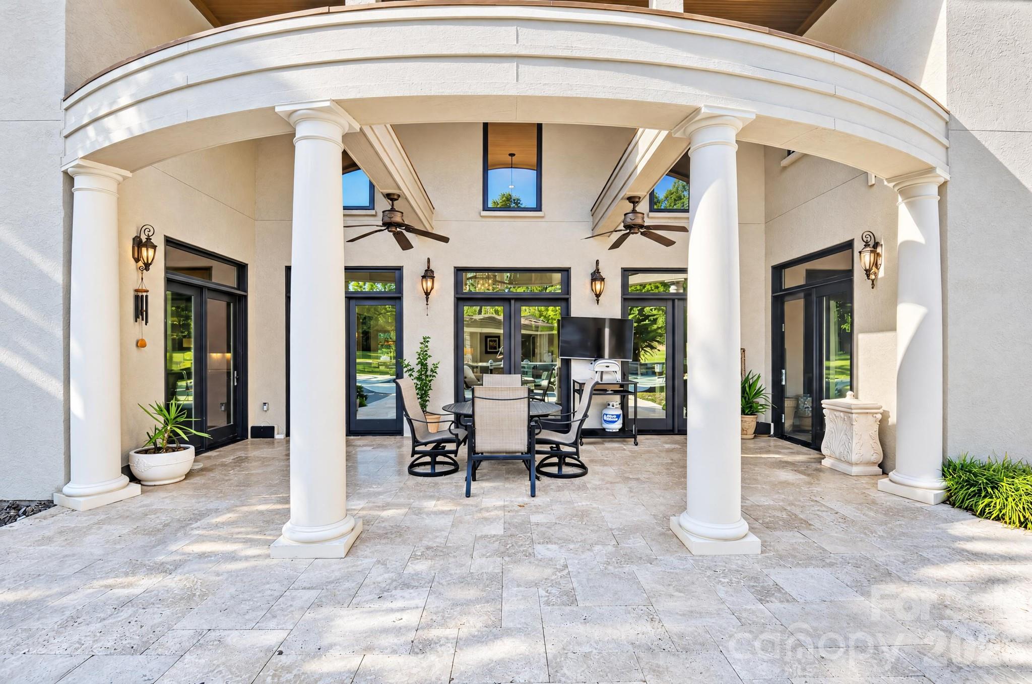 Covered patio with doors leading to the Enclosed Patio to the right and Breakfast Room on the left - 1340 Sardis Road N, Charlotte