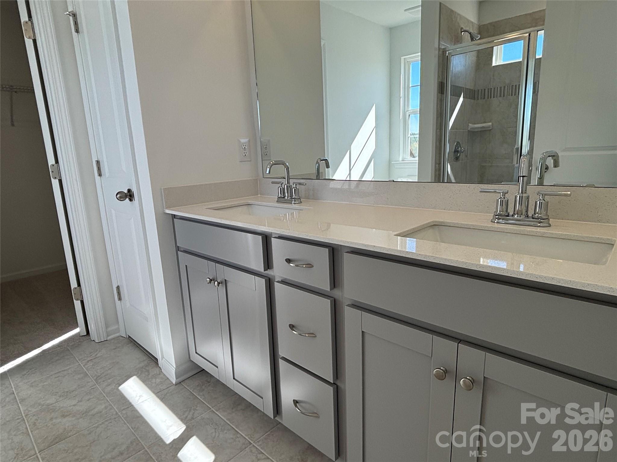 Tile floors, tile surround, transom window to let the natural light brighten up the bathroom! - 1645 Grassy Knoll Trail, Maiden