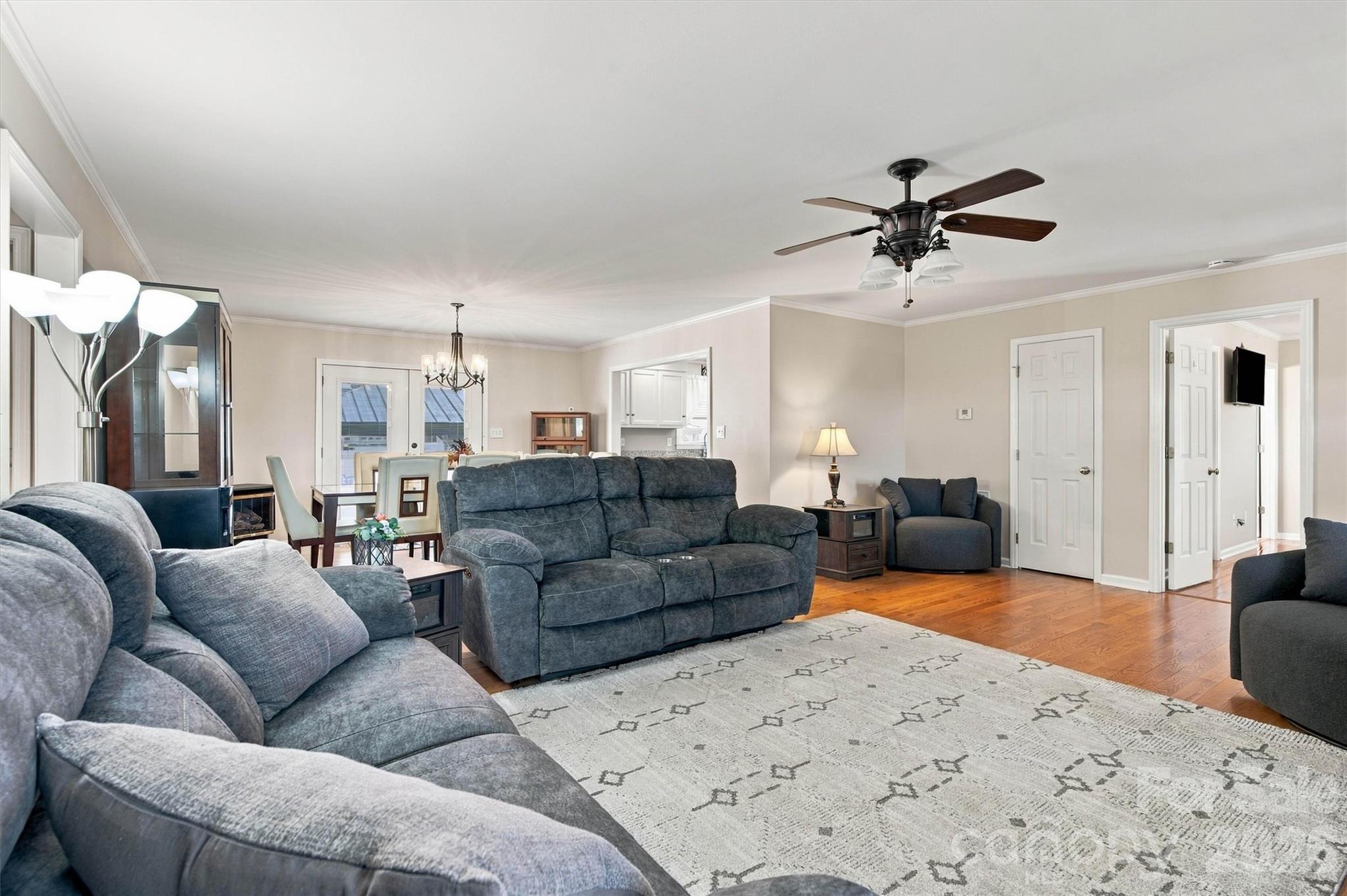 Living Room is quite large, able to accommodate large furniture. Ceiling fan, gleaming hardwood floors, open concept layout with Dining Area in back. - 643 Shoal Road, Lincolnton