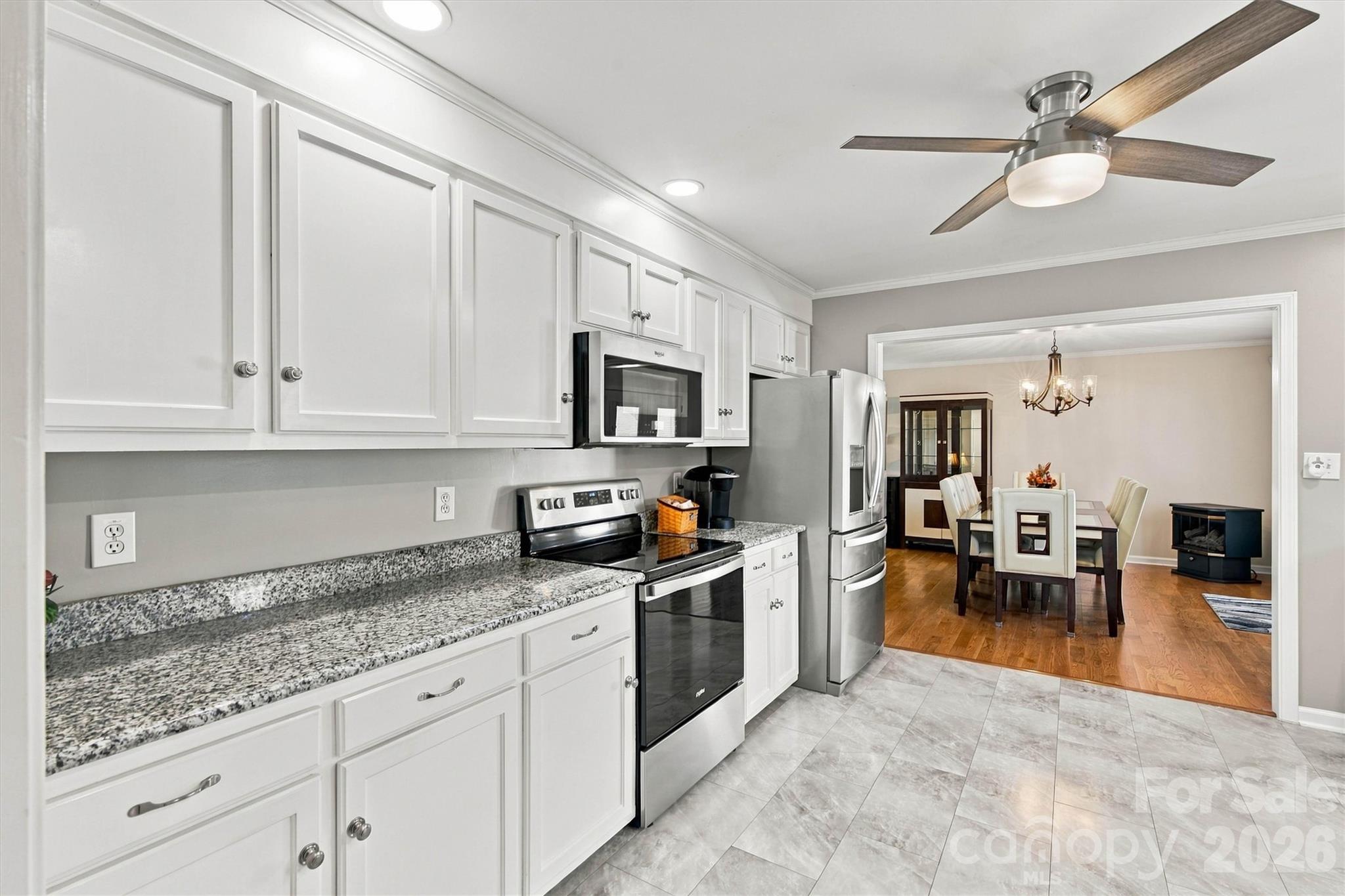 Nicely updated Kitchen with SS appliances, granite countertops, and gorgeous laminate flooring - 643 Shoal Road, Lincolnton