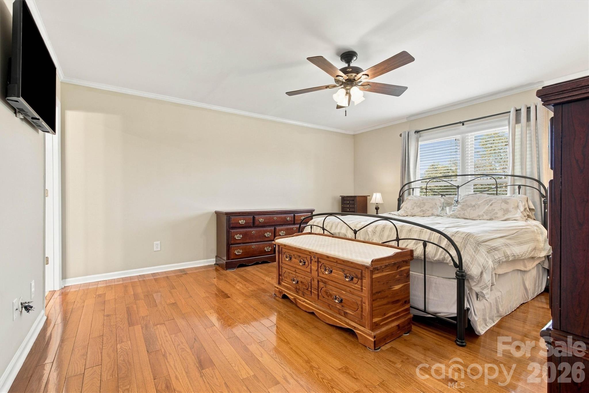 Another view of Primary Bedroom featuring gleaming hardwood floors and ceiling fan - 643 Shoal Road, Lincolnton