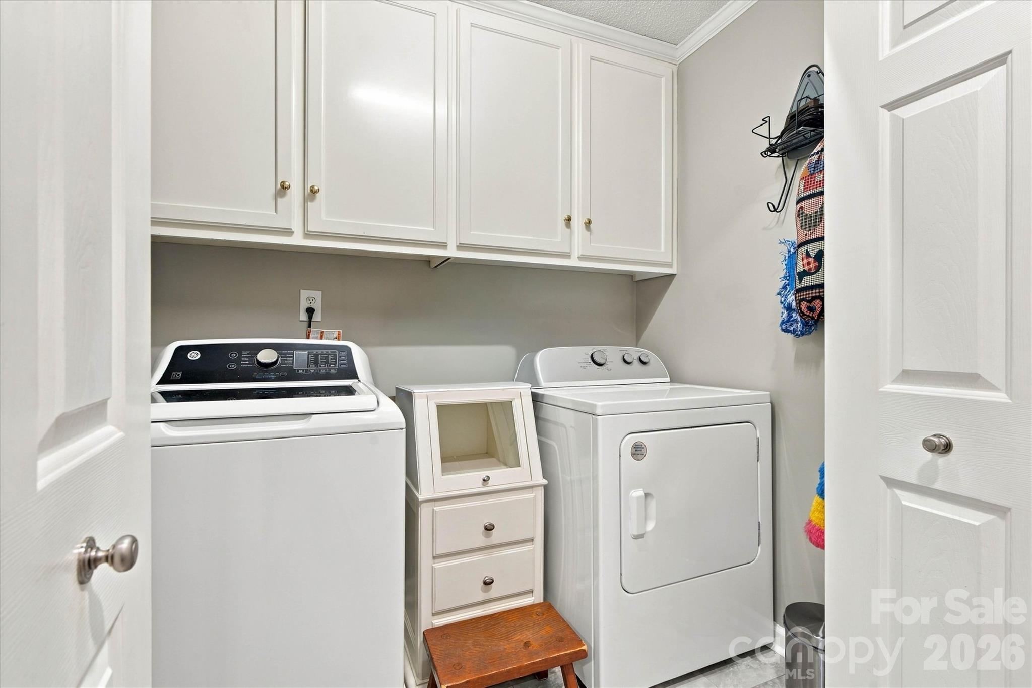 Spacious Laundry Room with cabinetry is located in Mud Room, between the garage entry door and kitchen - 643 Shoal Road, Lincolnton