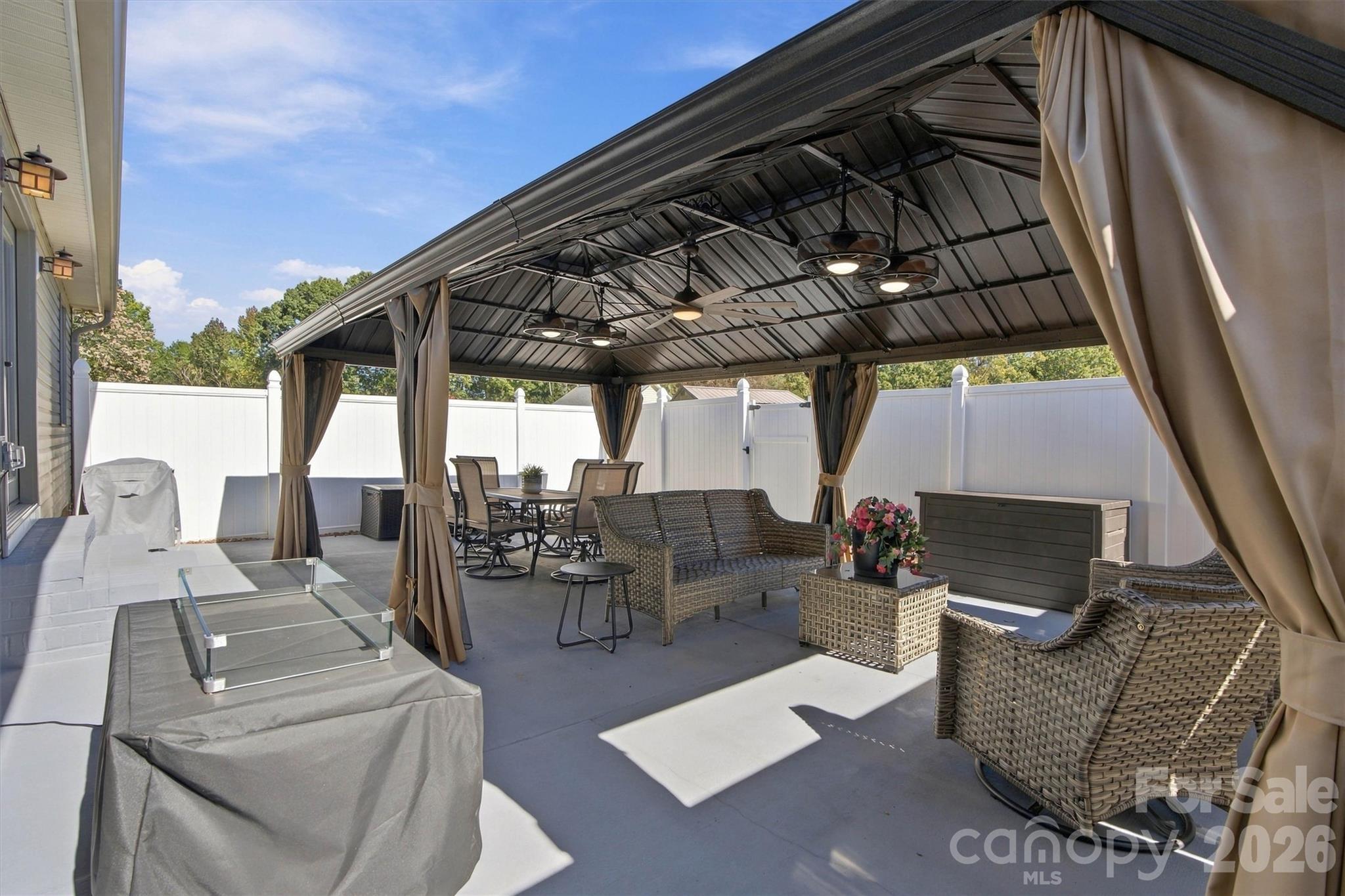 Privacy fence surrounds the gazebo and concrete patio, creating an amazing outdoor environment perfect for family and entertaining - 643 Shoal Road, Lincolnton