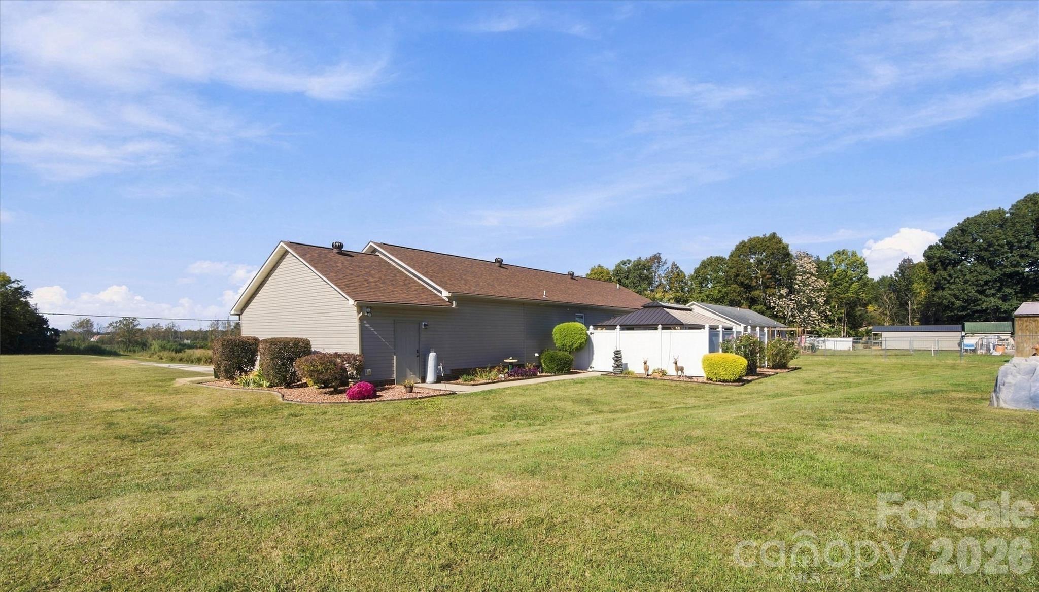 Rear of home showing fenced rear Patio and walk through door into attached garage. - 643 Shoal Road, Lincolnton