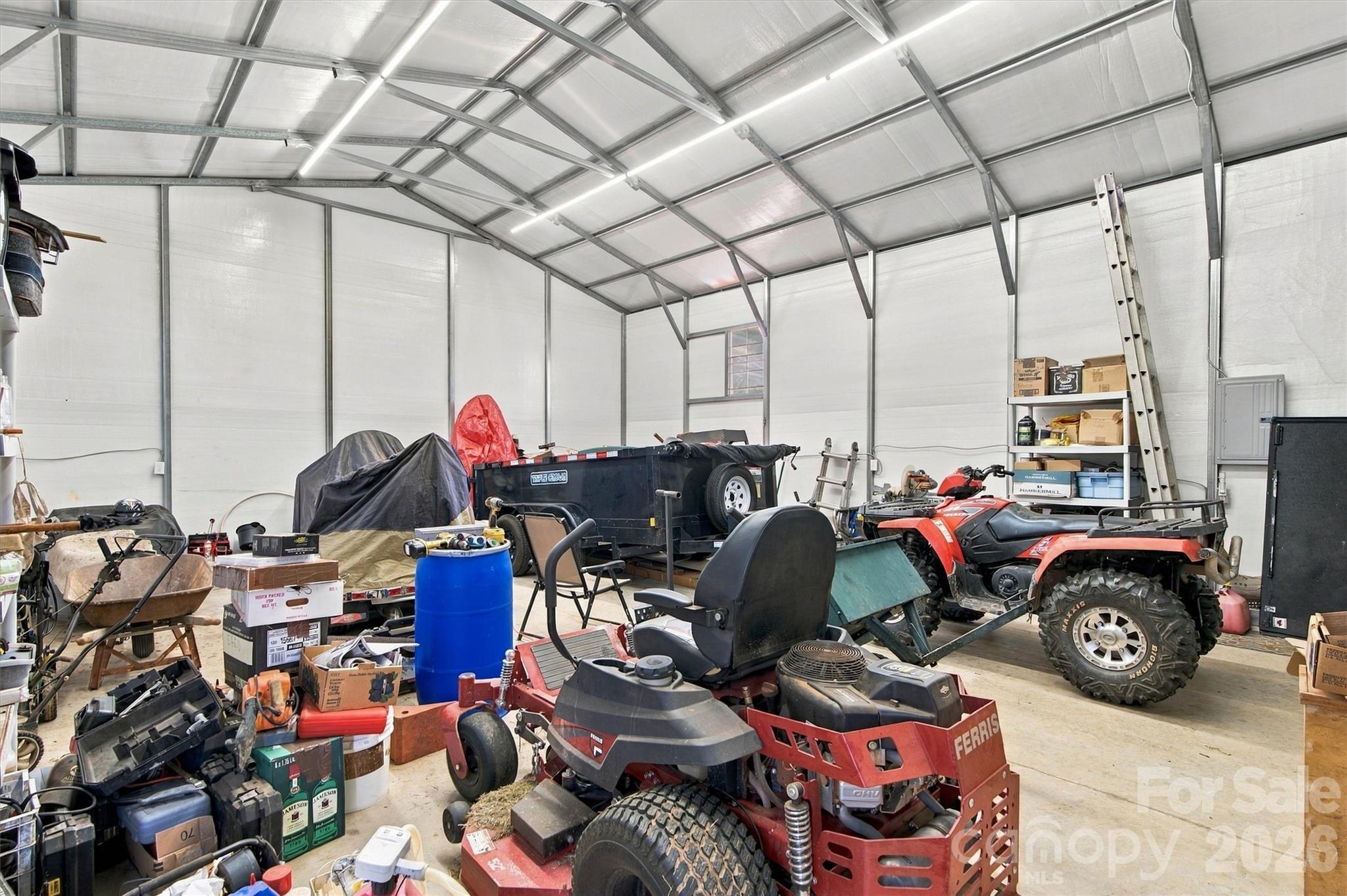 Interior of detached garage. Building is insulated, has 200amp power, concrete floor, walk through door, and two roll up garage doors. - 643 Shoal Road, Lincolnton